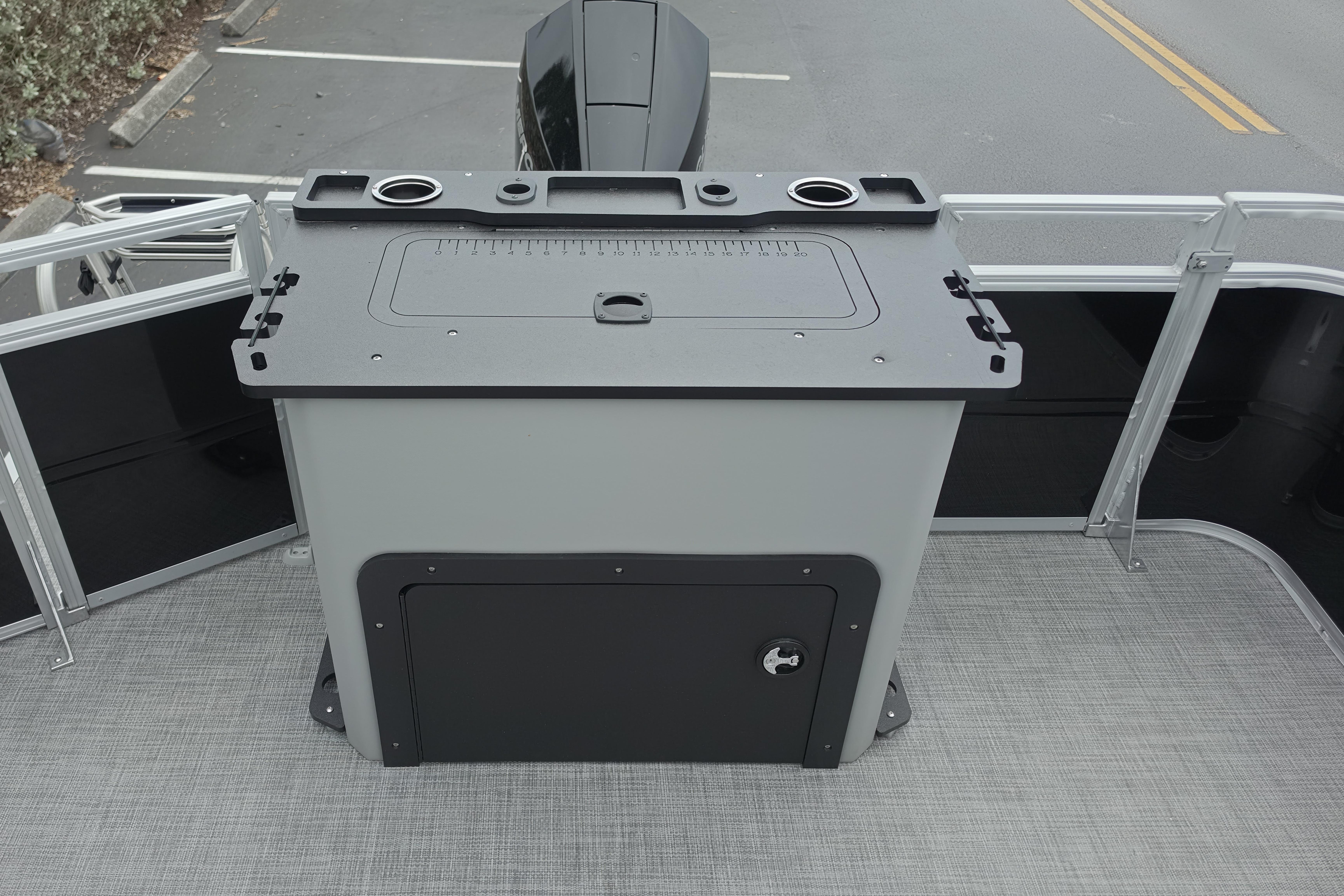 2026 Sun Tracker SportFish 22 XP3 boat deck with storage compartment and cup holders.