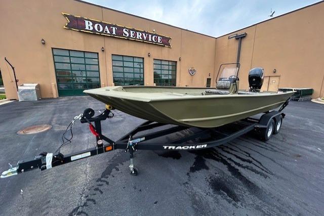 2026 Tracker Grizzly 2072 CC boat on trailer outside service center.