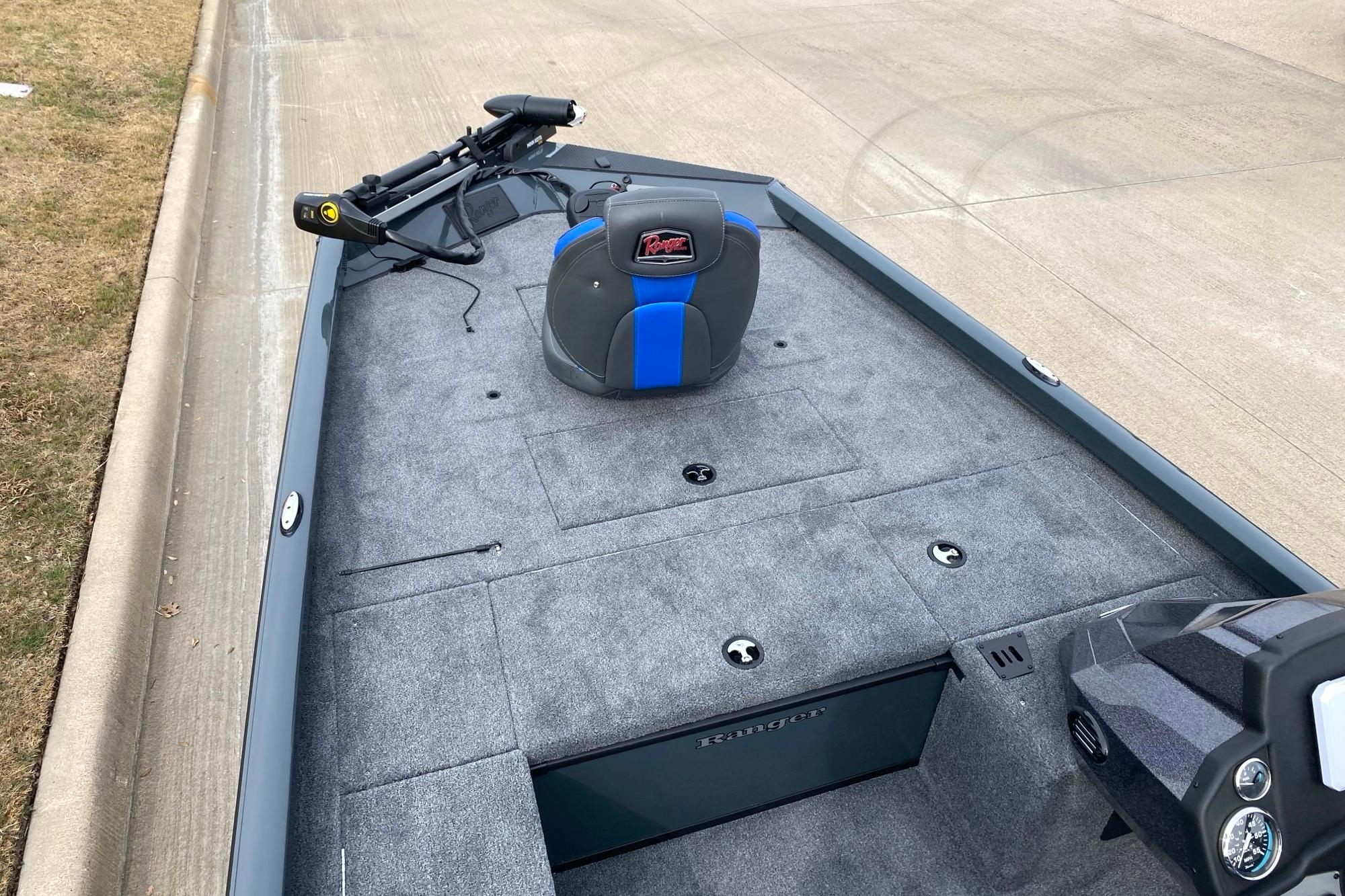 2026 Ranger RT188C boat interior with gray carpet and blue-accented seat.