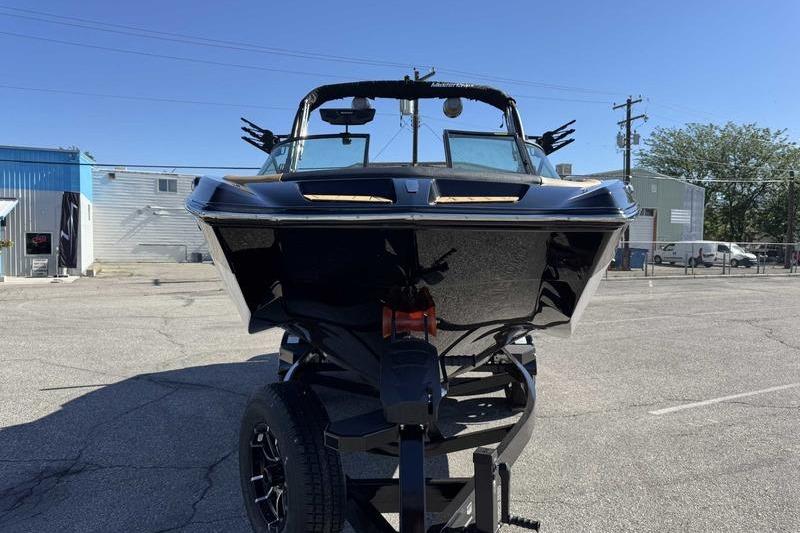 2026 MasterCraft XT22 boat on trailer in parking lot, front view.