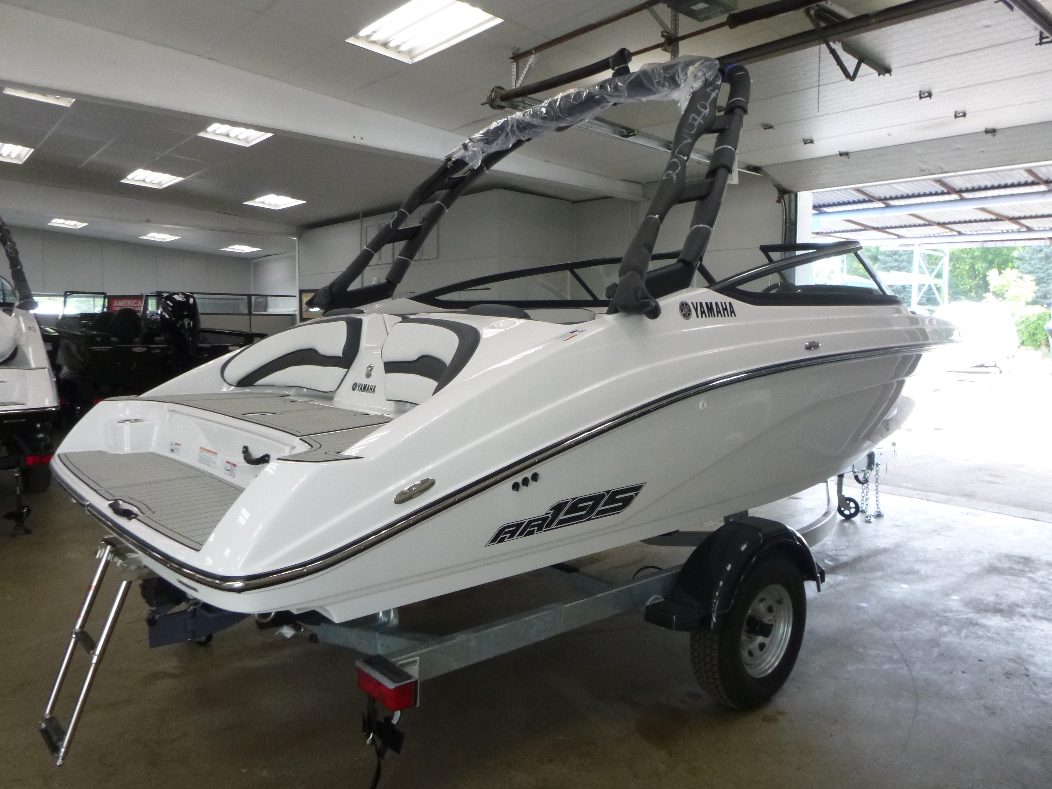 2025 Yamaha AR195 boat in showroom, sleek white design on trailer.