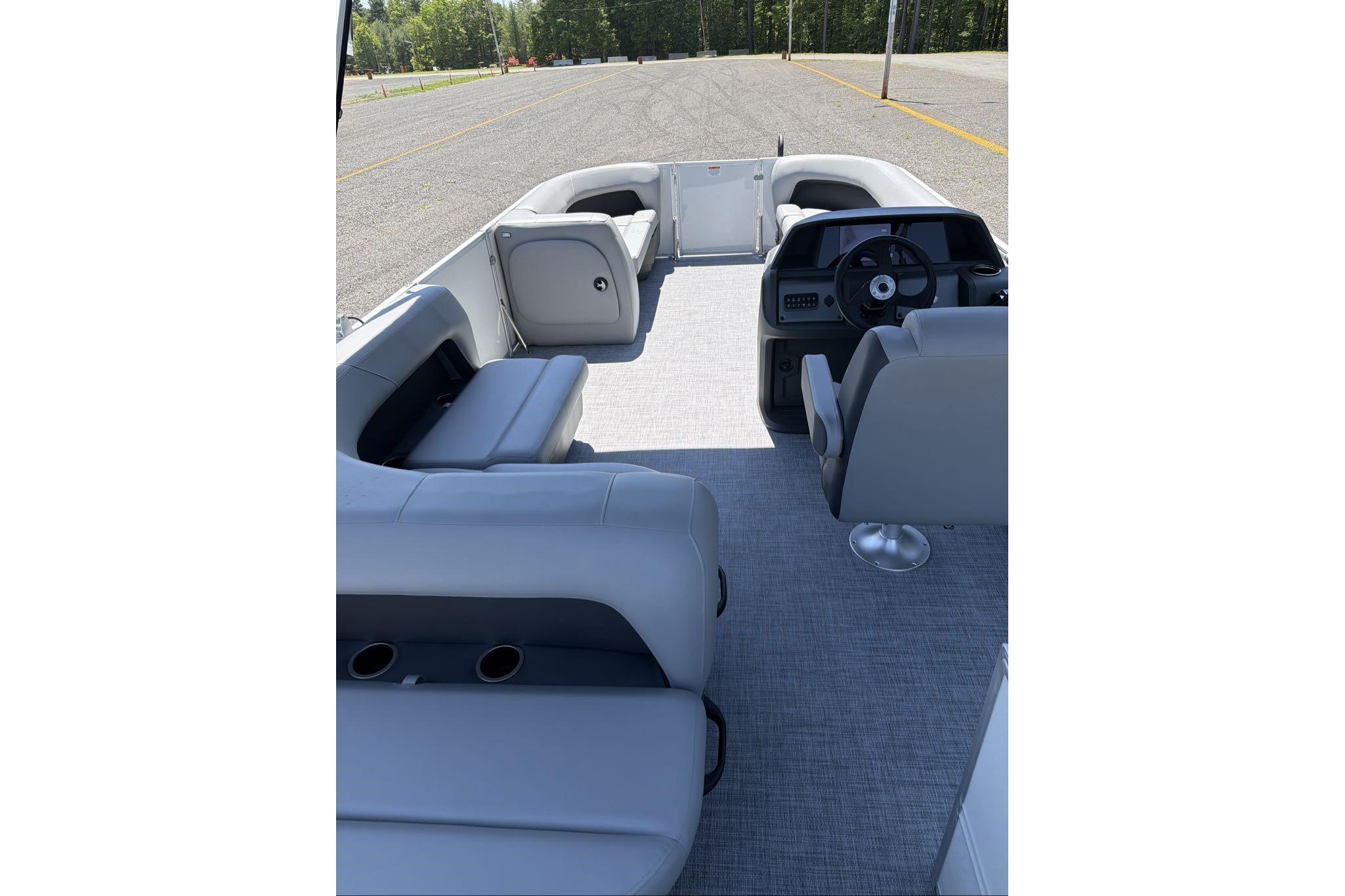 2026 Sun Tracker Party Barge 18 DLX interior with seating and steering console.