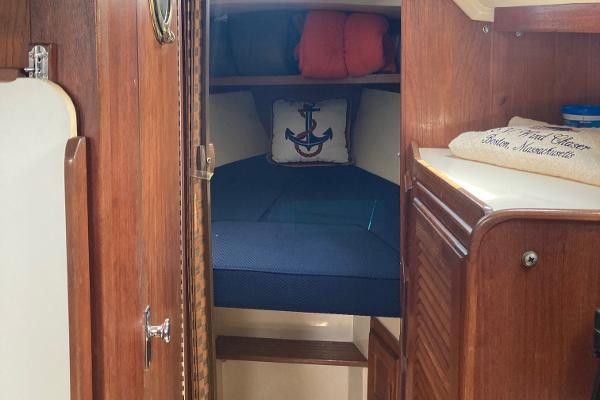 Cozy cabin interior of 1989 Catalina 30 sailboat with nautical decor.