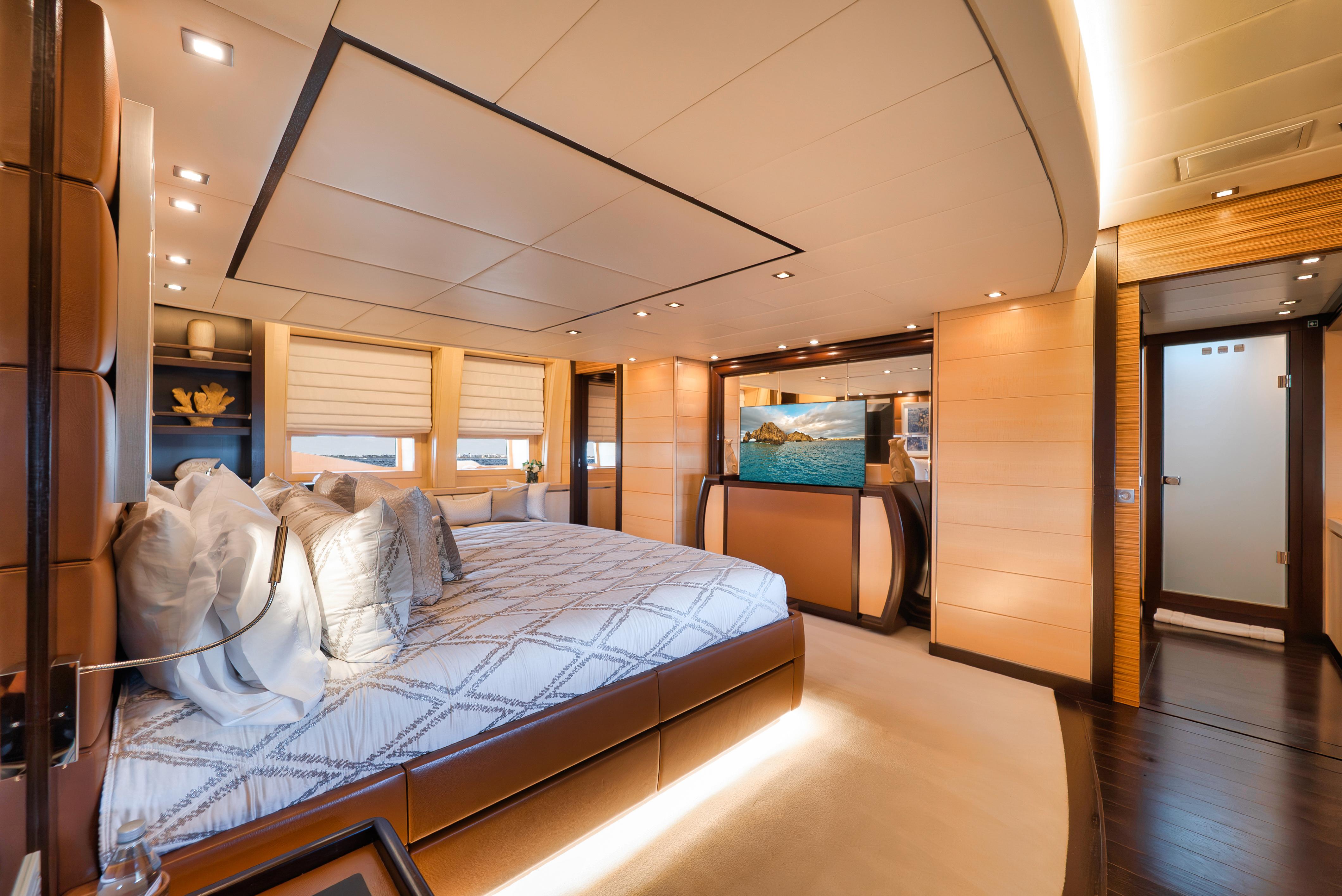Luxurious bedroom interior on 2010 Arno Leopard 46 yacht, featuring elegant design and ambient lighting.