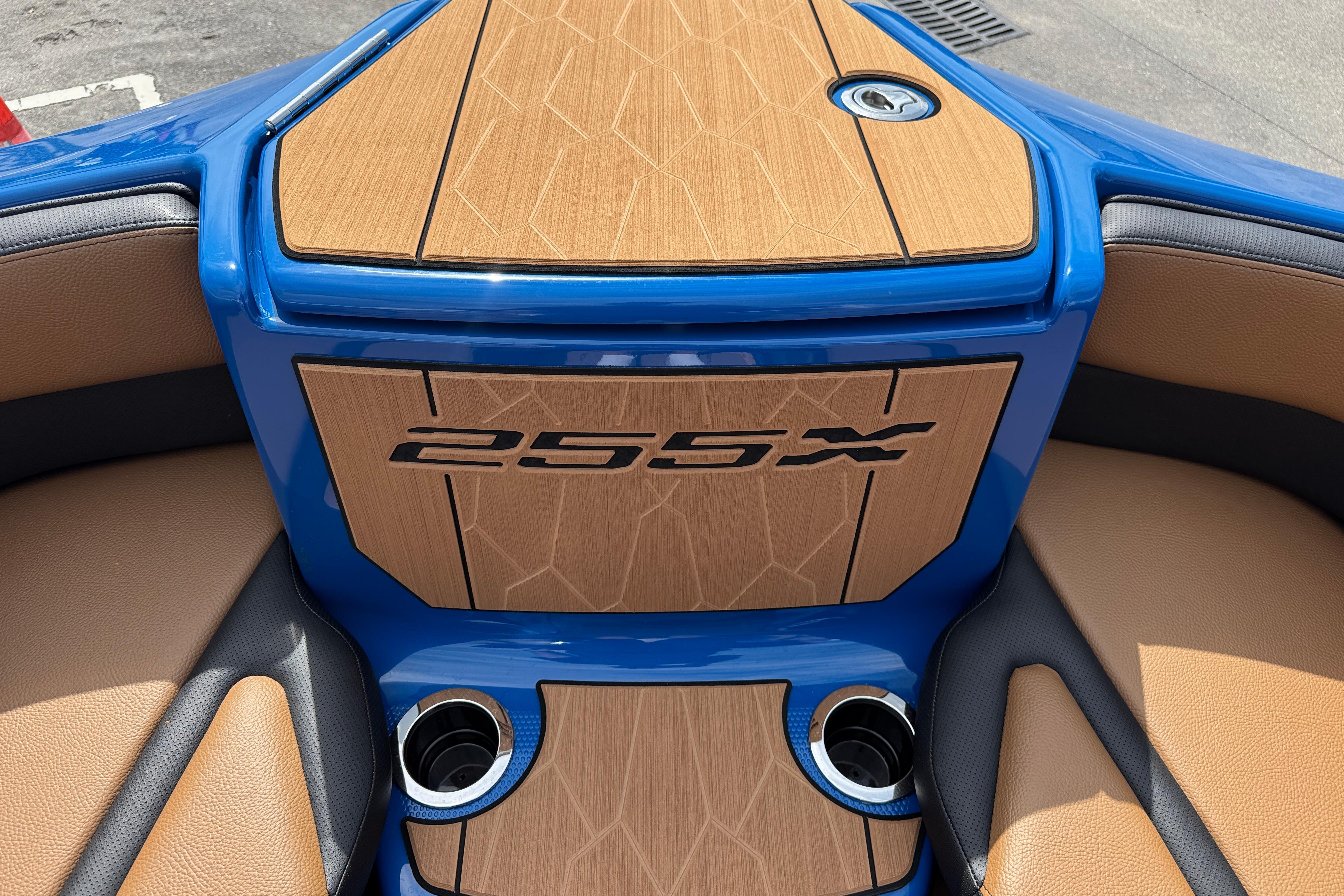 2026 Yamaha Boats 255XD interior with wood accents and blue trim.