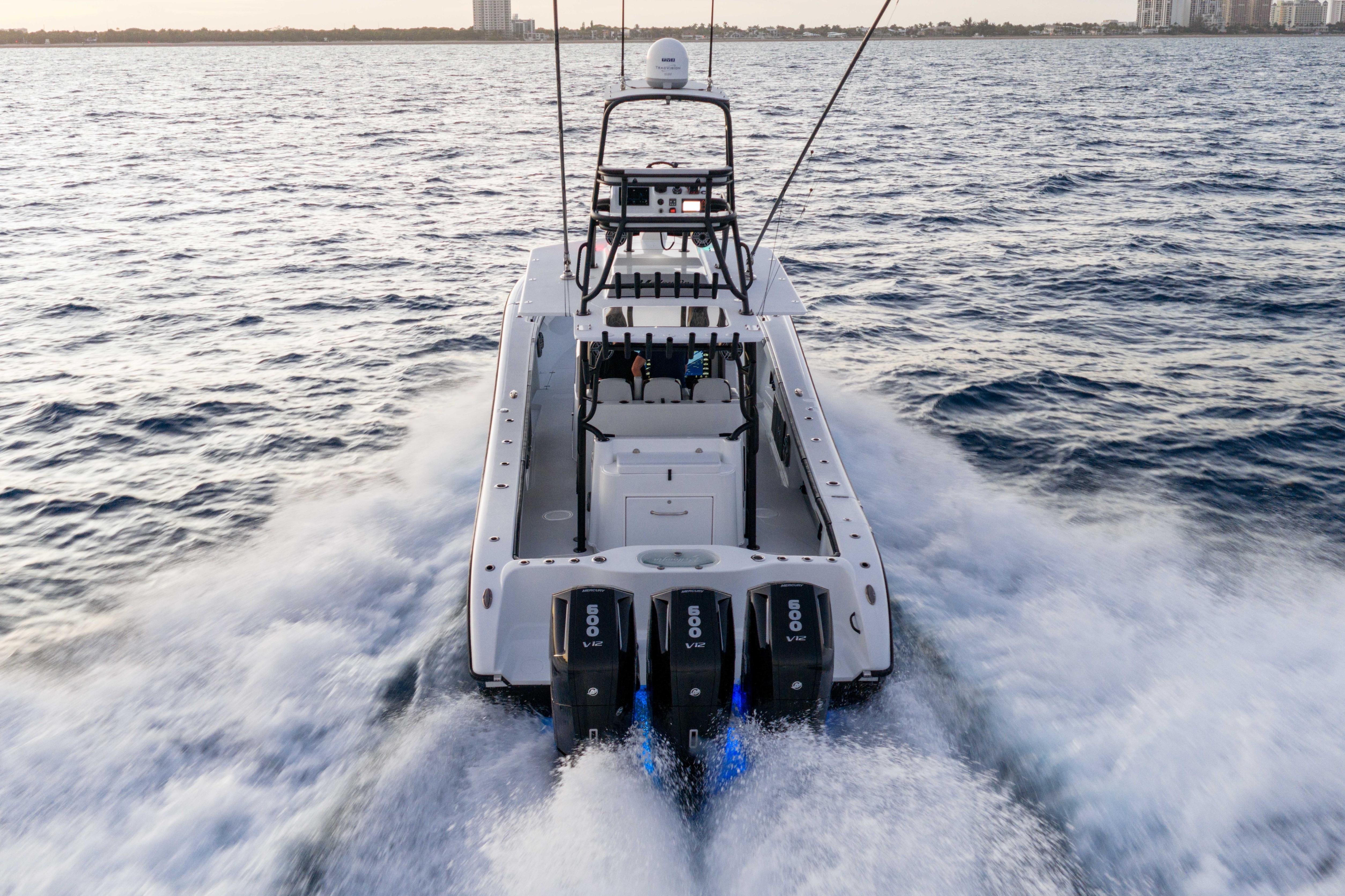 2023 Yellowfin 42 Offshore boat cruising on open water, rear view.