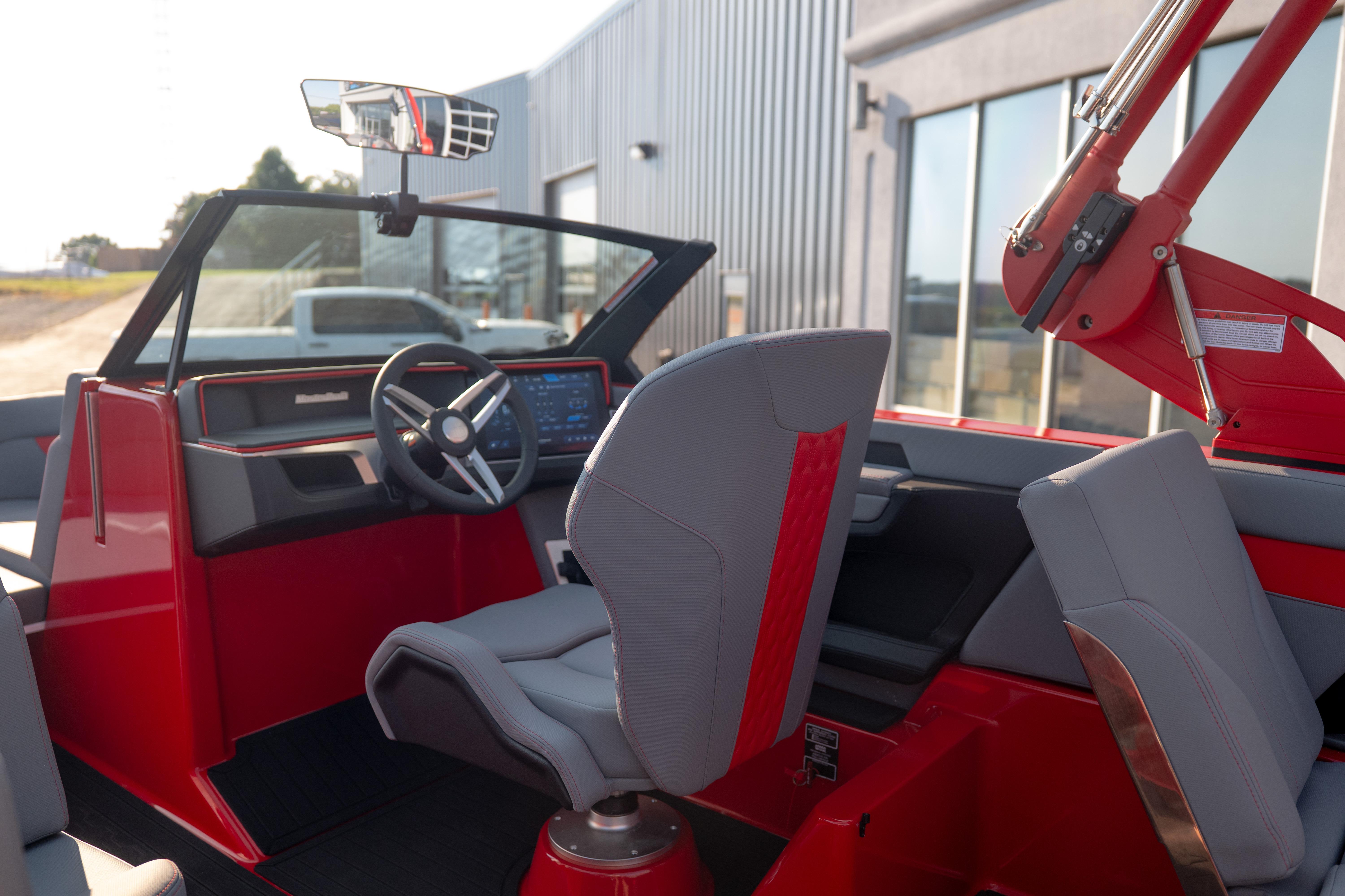 2027 MasterCraft XT24 boat interior with modern dashboard and sleek red accents.