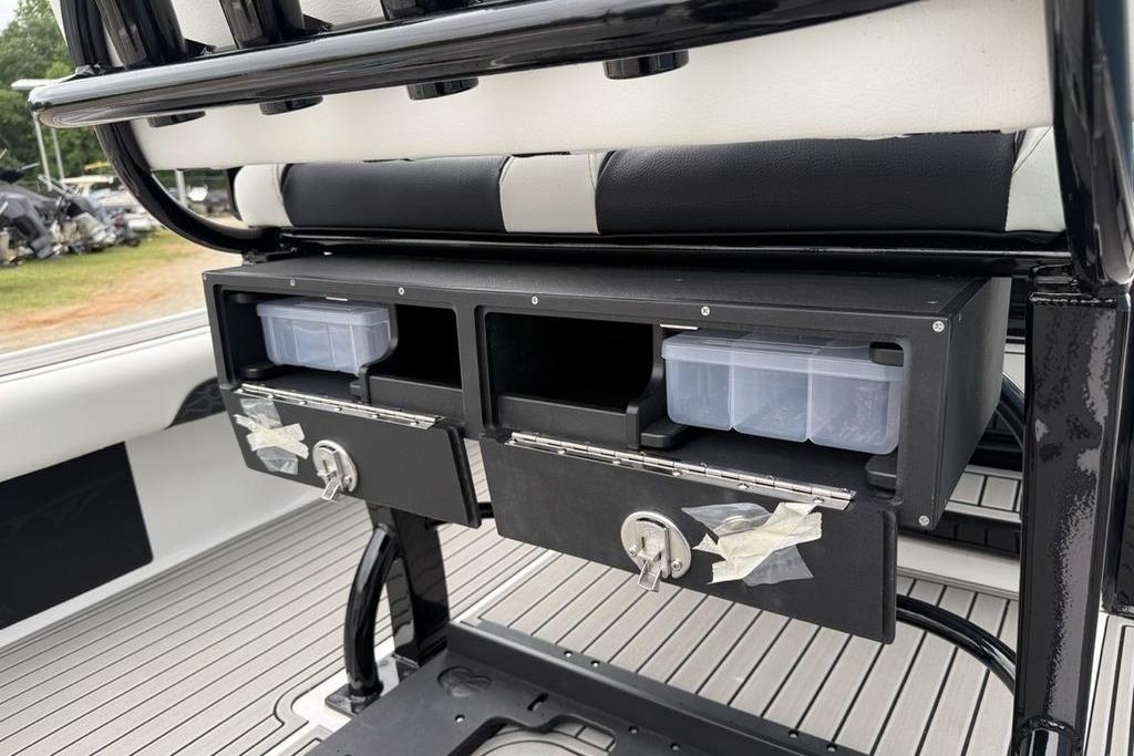 Storage compartments on a 2026 Tidewater 2500 Carolina Bay boat, featuring organized tackle boxes.