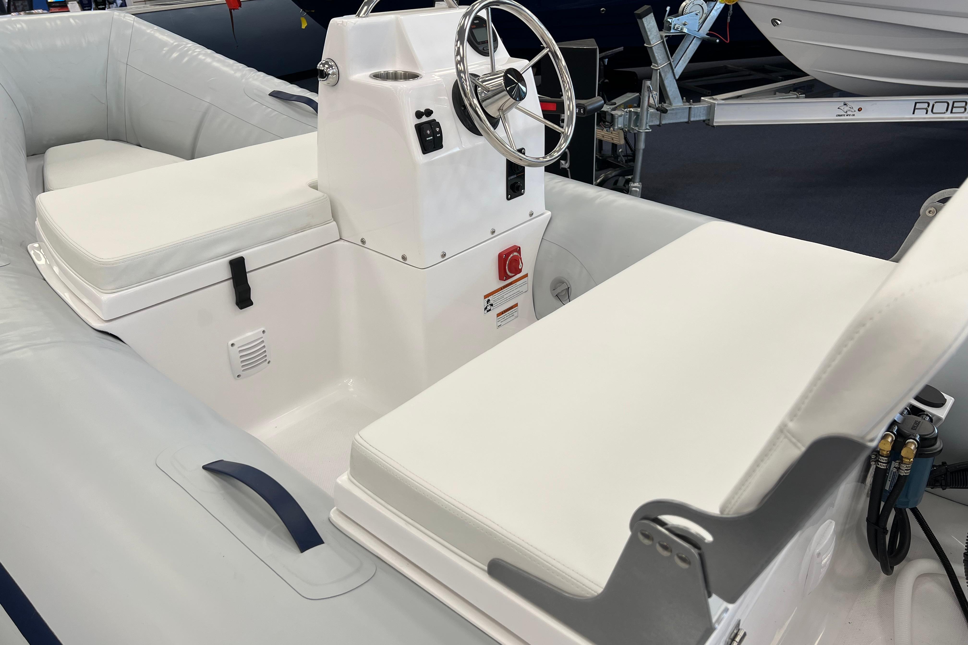 2023 AB Inflatables Mares 12 VSX boat interior with white seating and steering console.