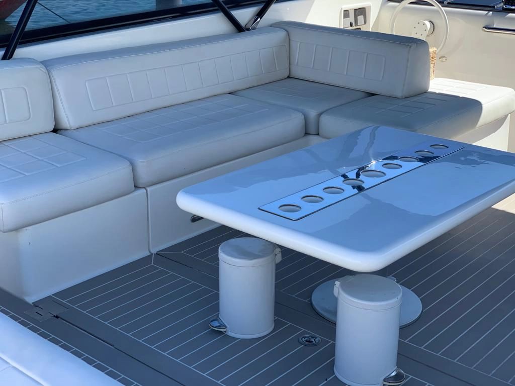 Interior of a 2014 VanDutch 55 boat with white sofa and table.