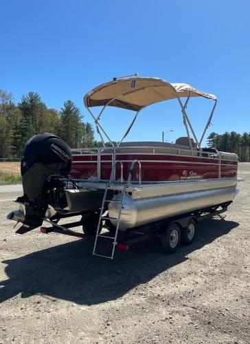 2025 Sun Tracker Party Barge 22 RF DLX pontoon boat with canopy and trailer.