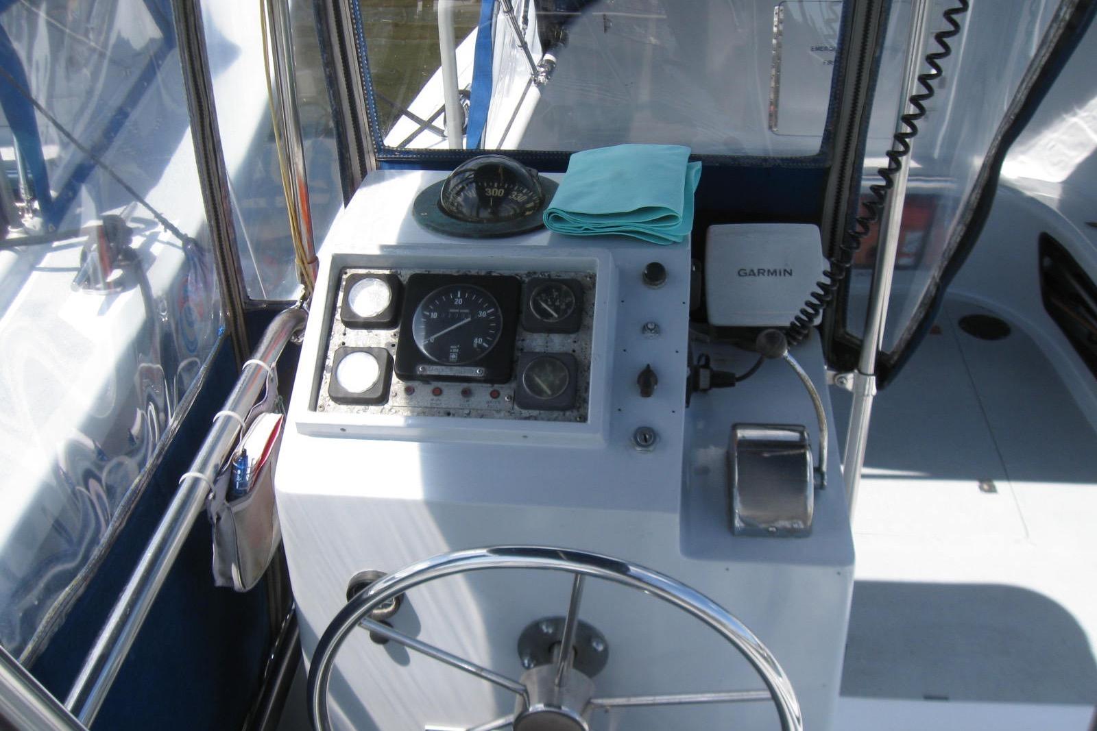 Cockpit of a 1994 Willard US Navy boat with steering wheel and navigation instruments.