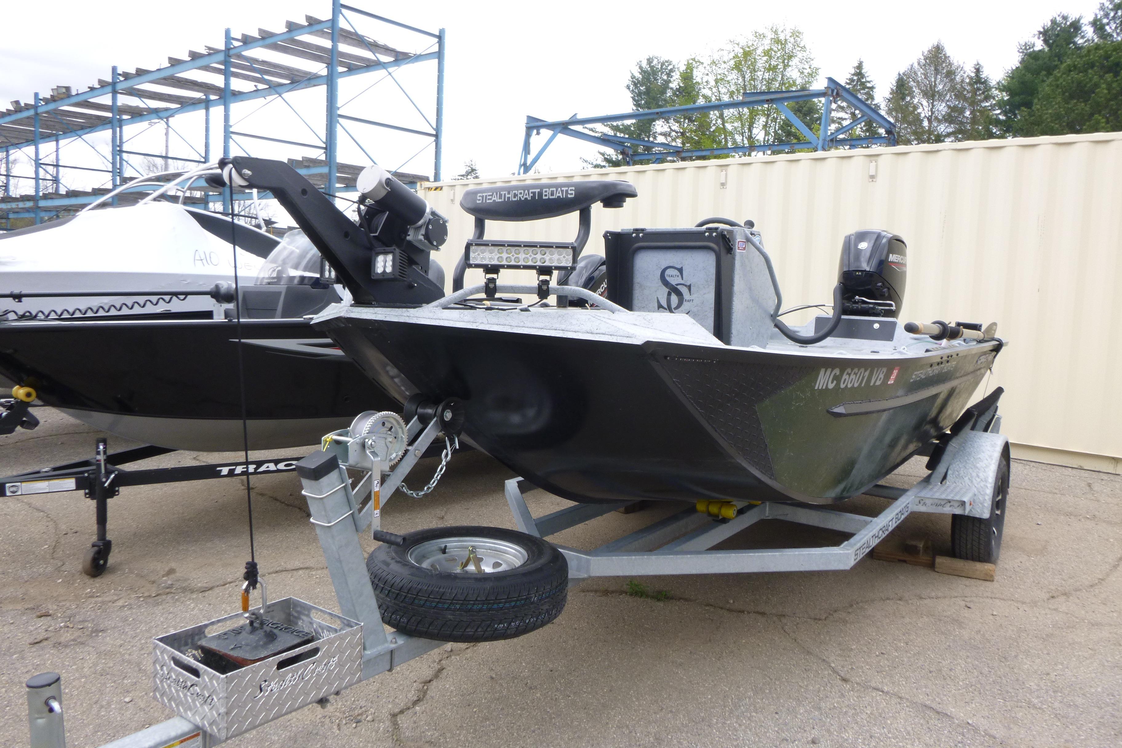 2025 StealthCraft 16 StealthWeld boat on trailer, parked outdoors.
