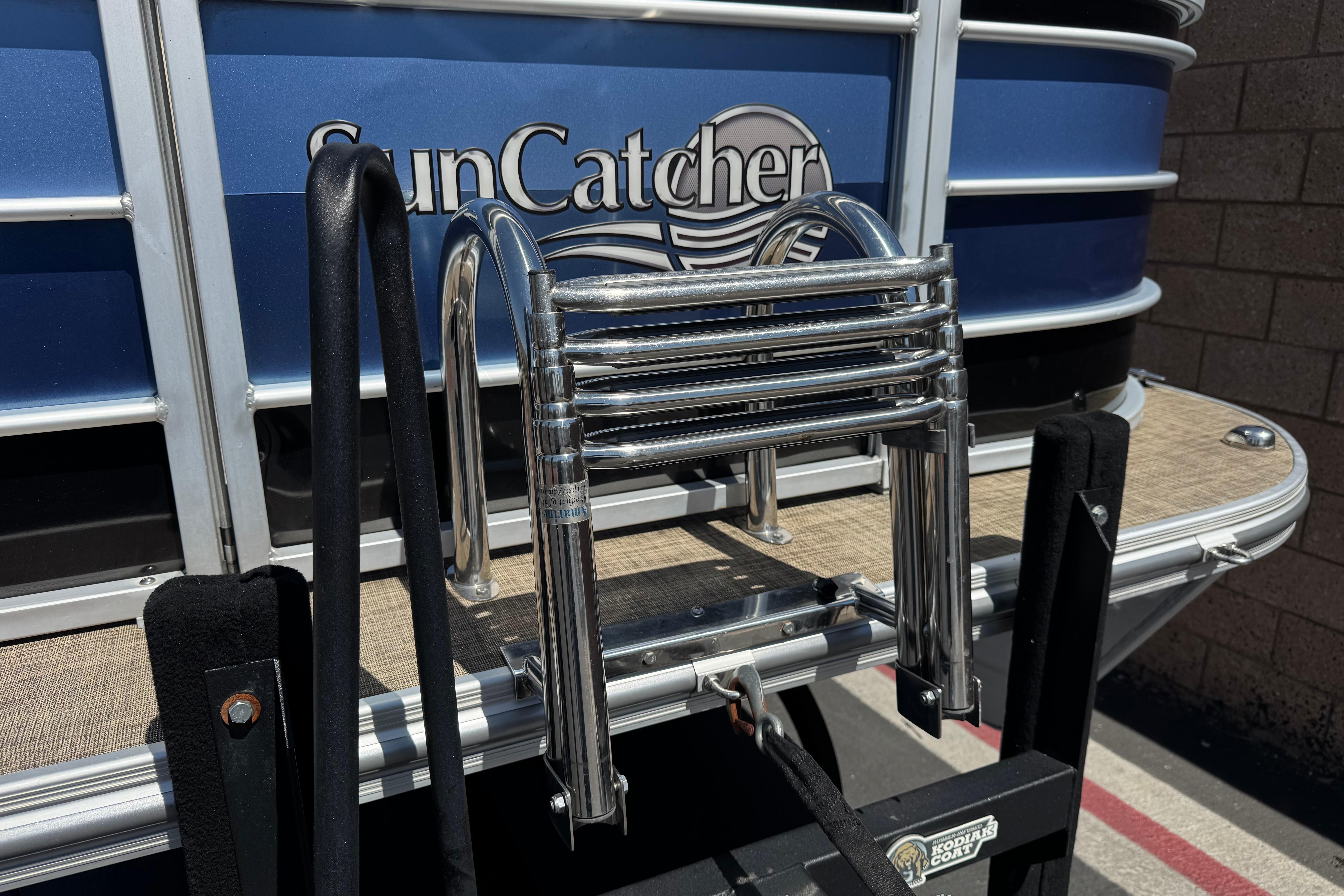 2021 SunCatcher Select 20RCX pontoon boat with stainless steel ladder and blue exterior.