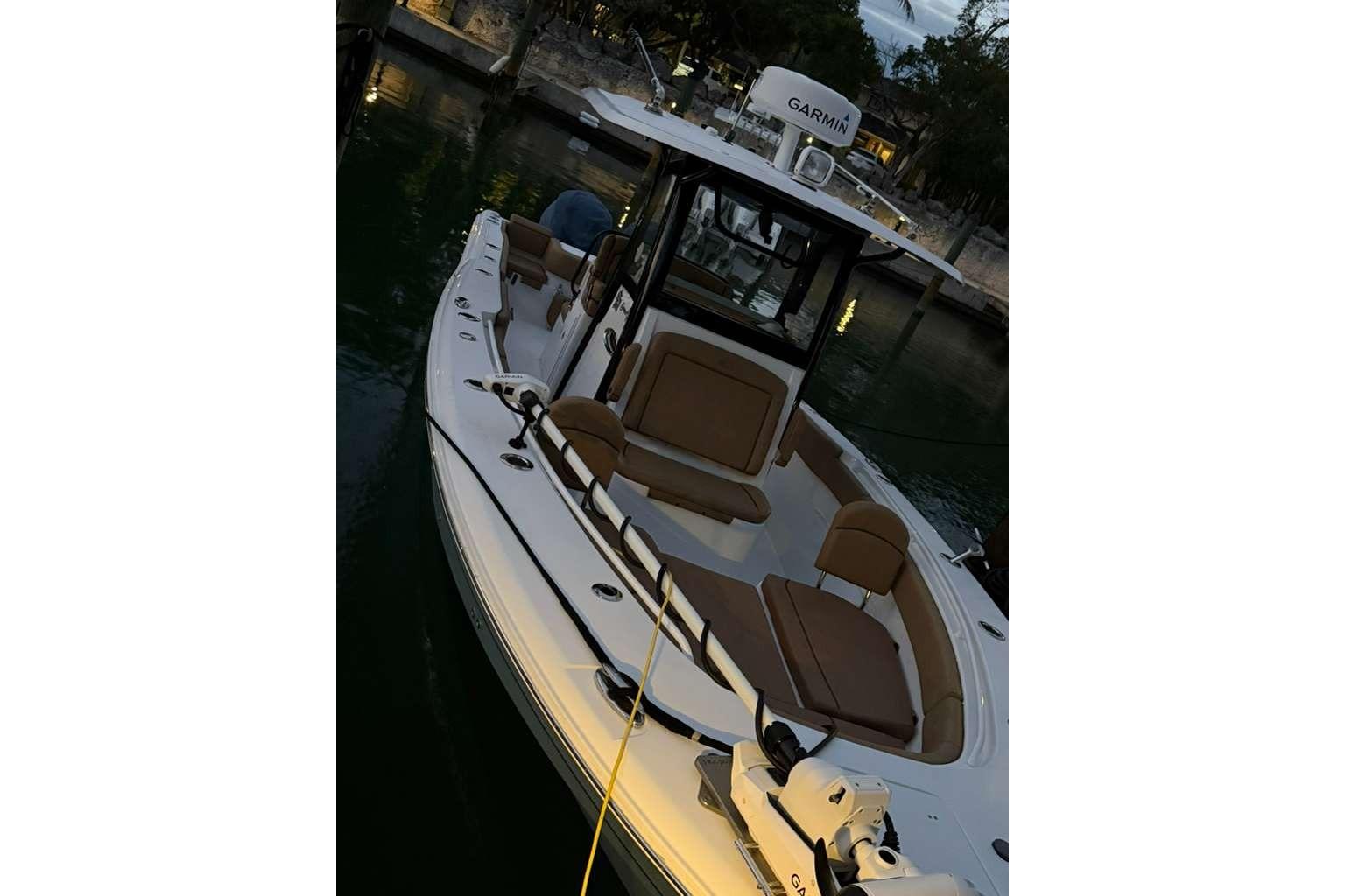 2021 Sea Hunt Gamefish 30 Forward Seating boat docked at marina.