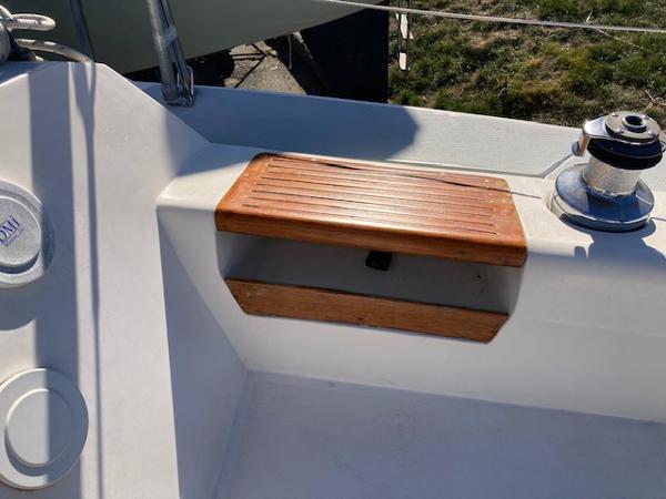 Cockpit detail of 1989 Catalina 30 sailboat with wooden step and winch.