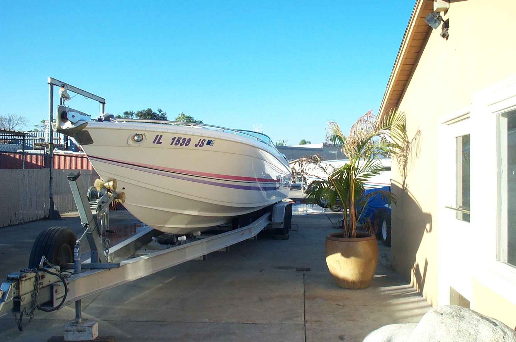 1993 Formula 419 boat on trailer beside building.