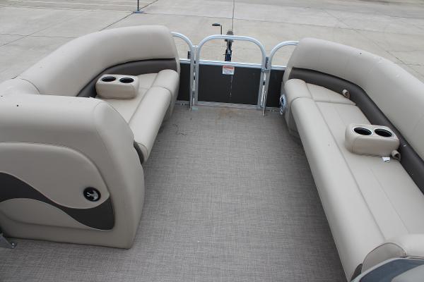 2025 Sun Tracker Party Barge 18 DLX interior with beige seating and cup holders.