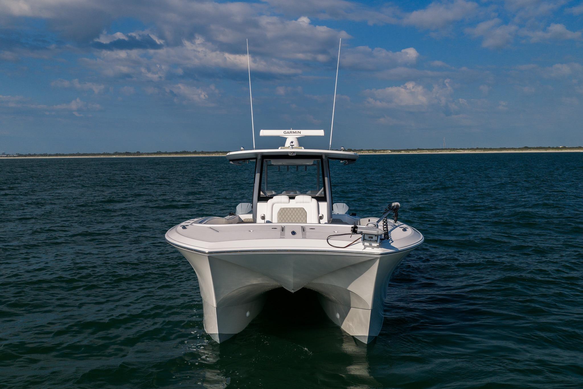 2026 Front Runner 37 Catamaran on open water under a partly cloudy sky.