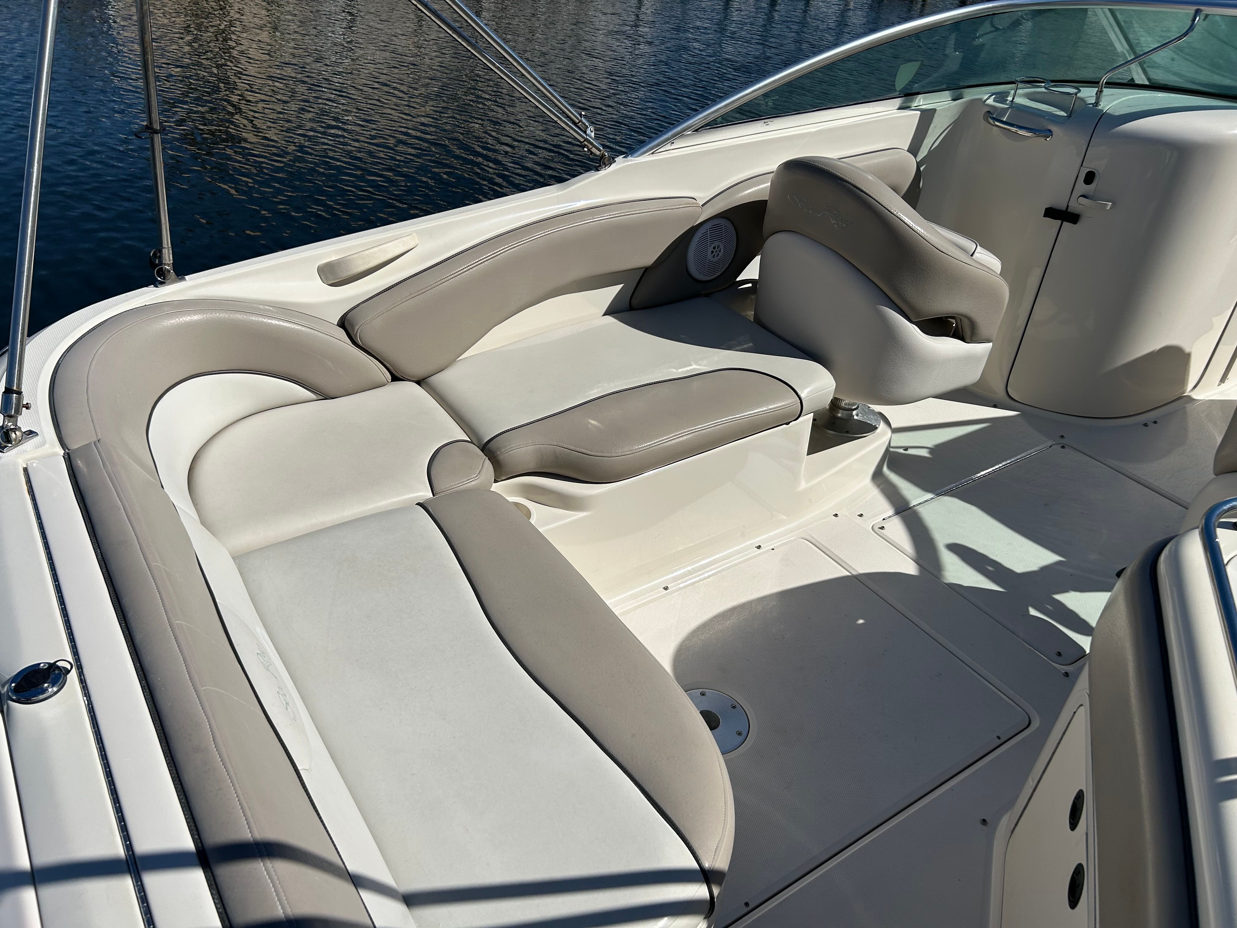 Interior of a 2003 Sea Ray 240 Sundeck boat with beige seating.