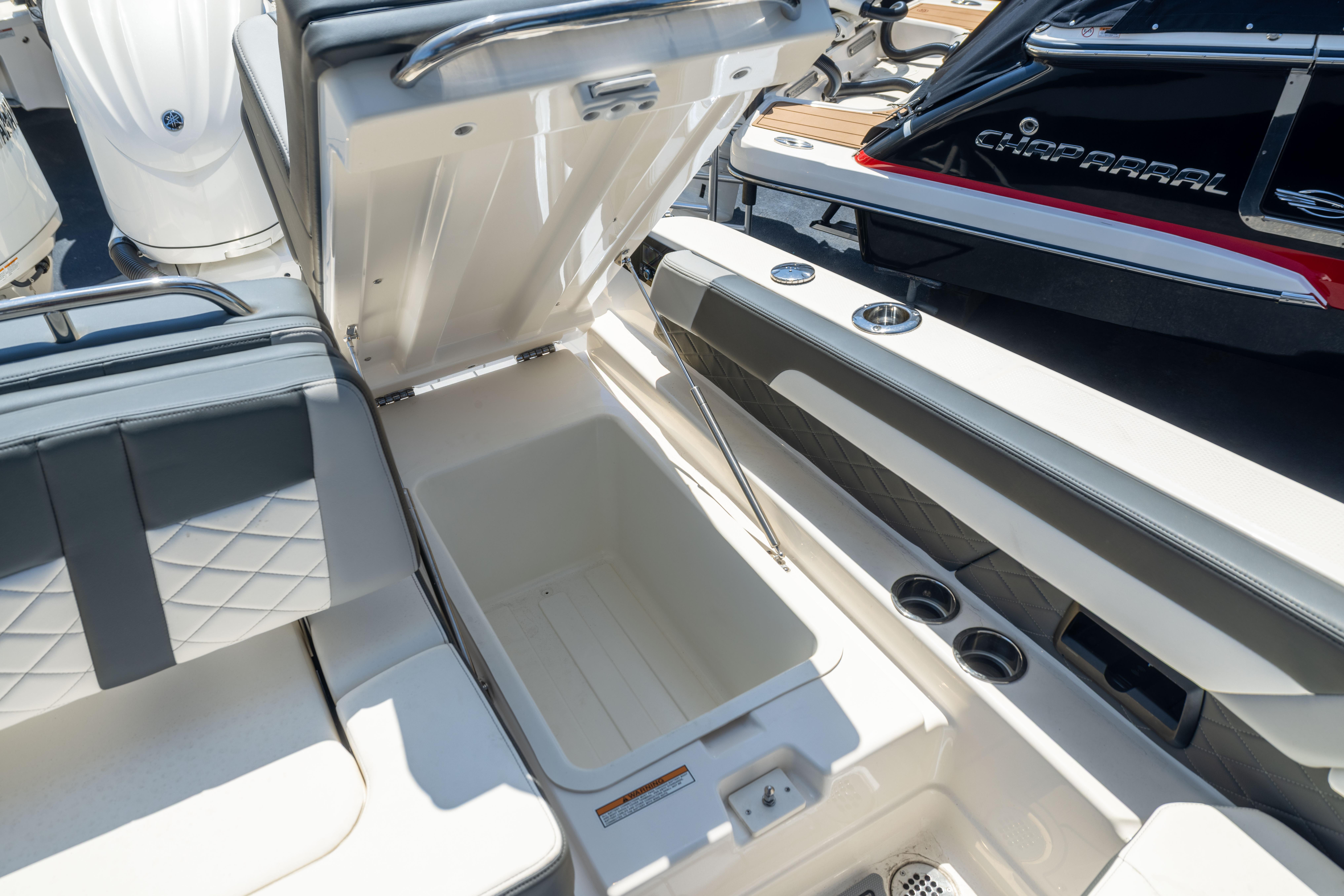 2026 Chaparral 310 OSX boat interior with open storage compartment and seating.