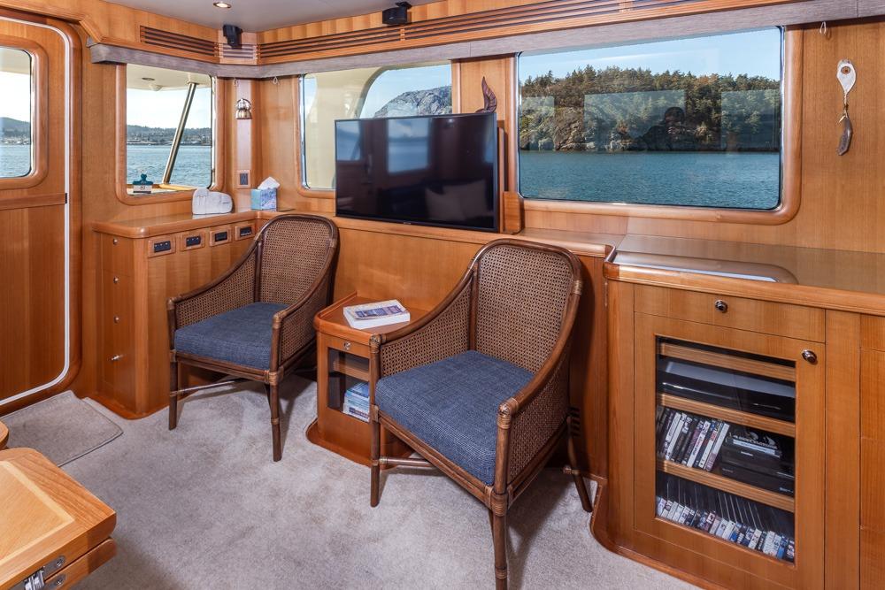 Luxurious interior of 2009 Selene 60 Ocean Trawler with elegant wood finish and scenic views.
