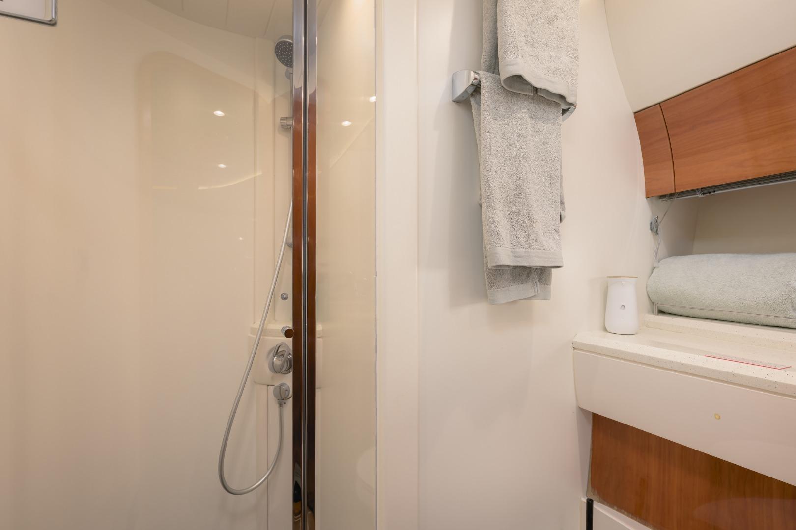 Bathroom interior of a 2001 Princess 61 yacht, featuring a shower and towels.