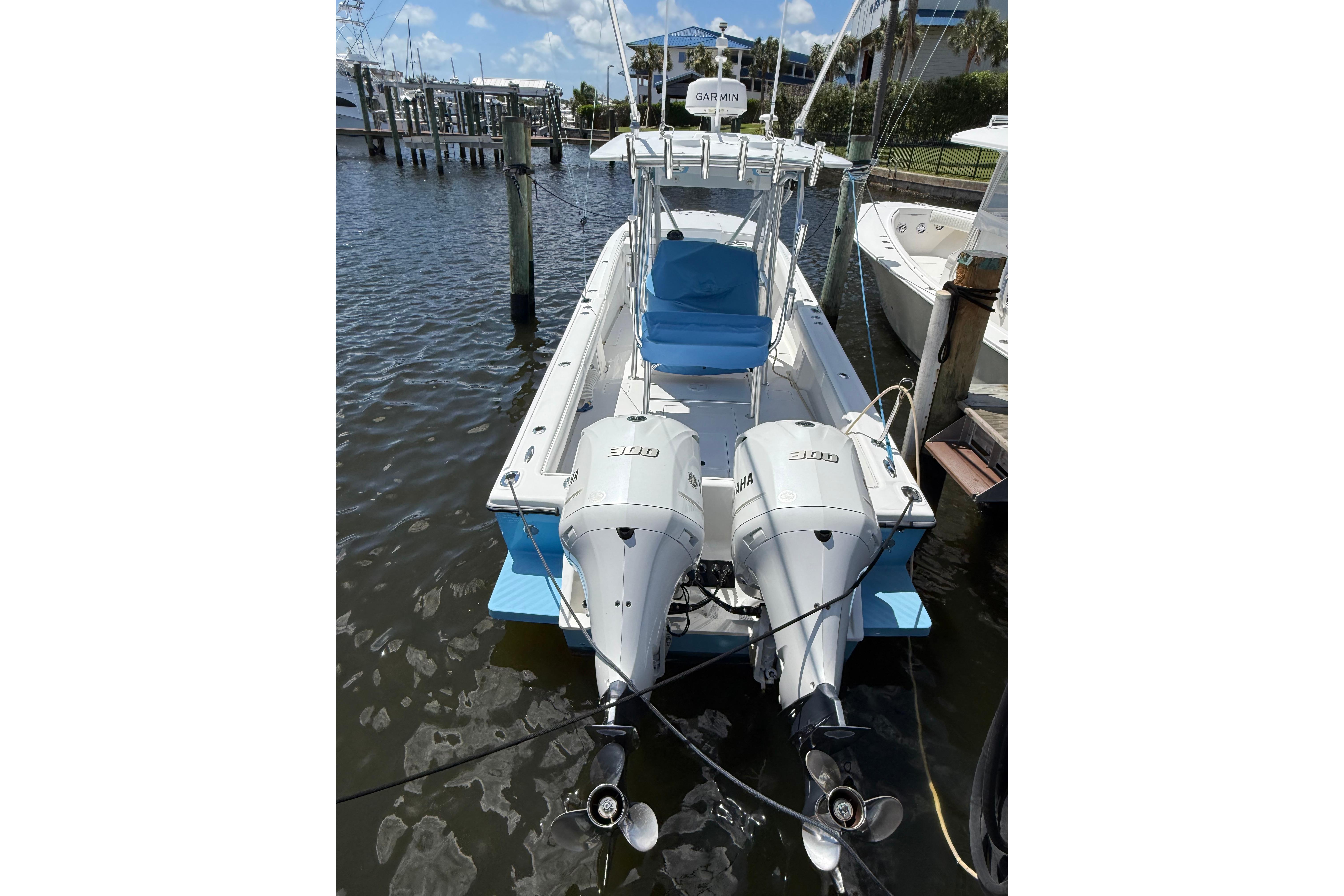 1992 Intrepid 289 Center Console boat with twin Yamaha 300 engines docked at marina.