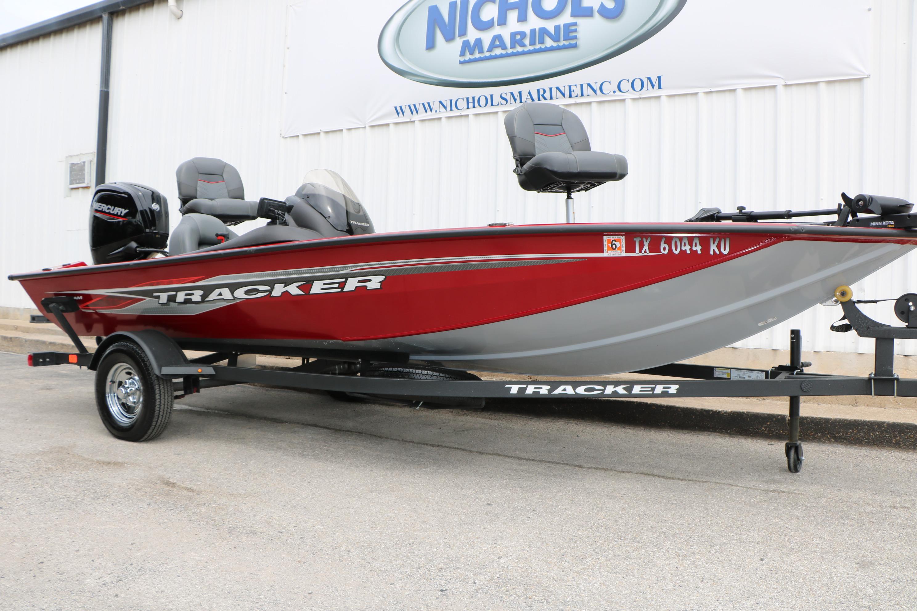 2024 Tracker Pro Team 175 boat in red, displayed on a trailer outside Nichols Marine.