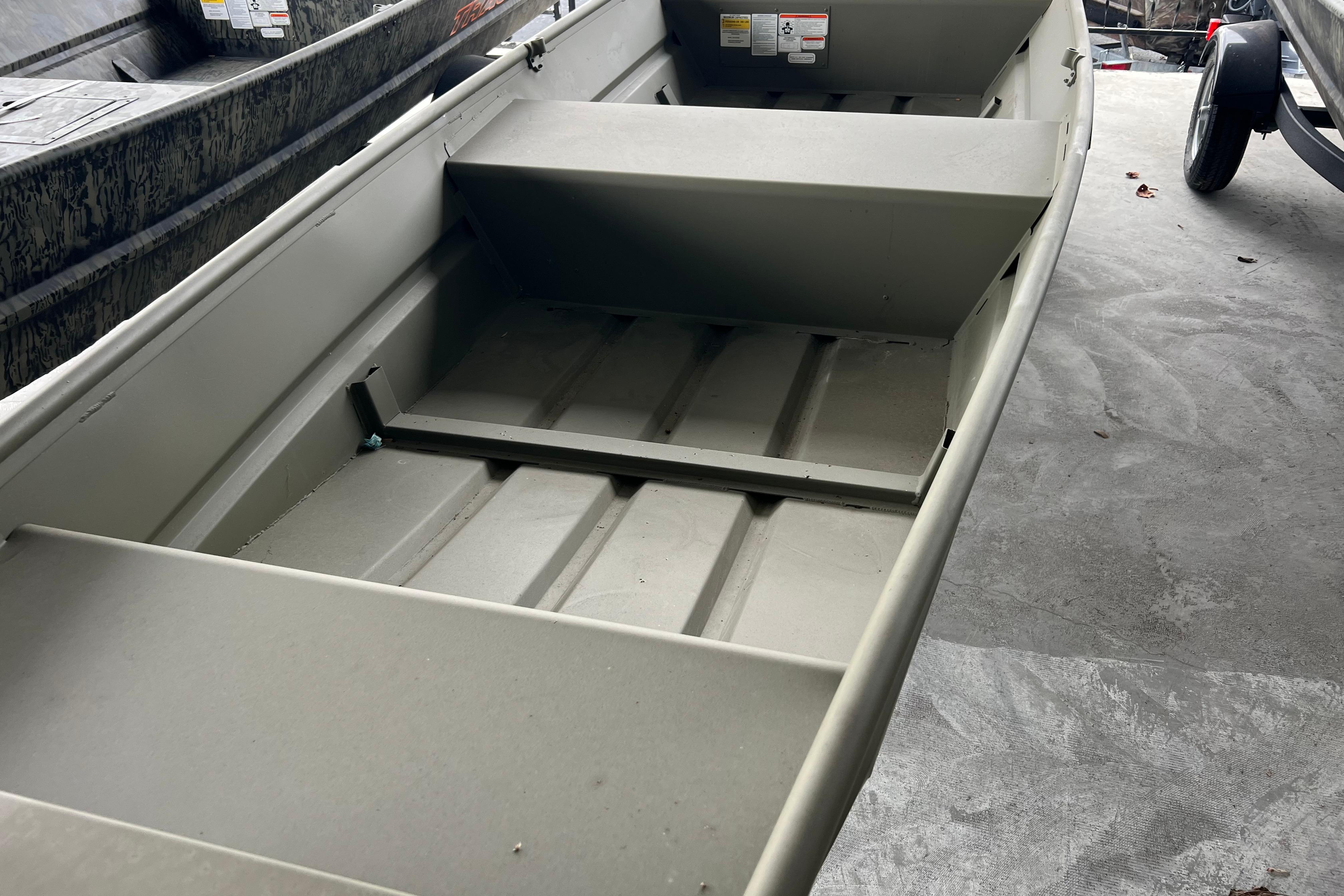 2026 Tracker Grizzly 14 Jon boat interior, showcasing seating and storage areas.