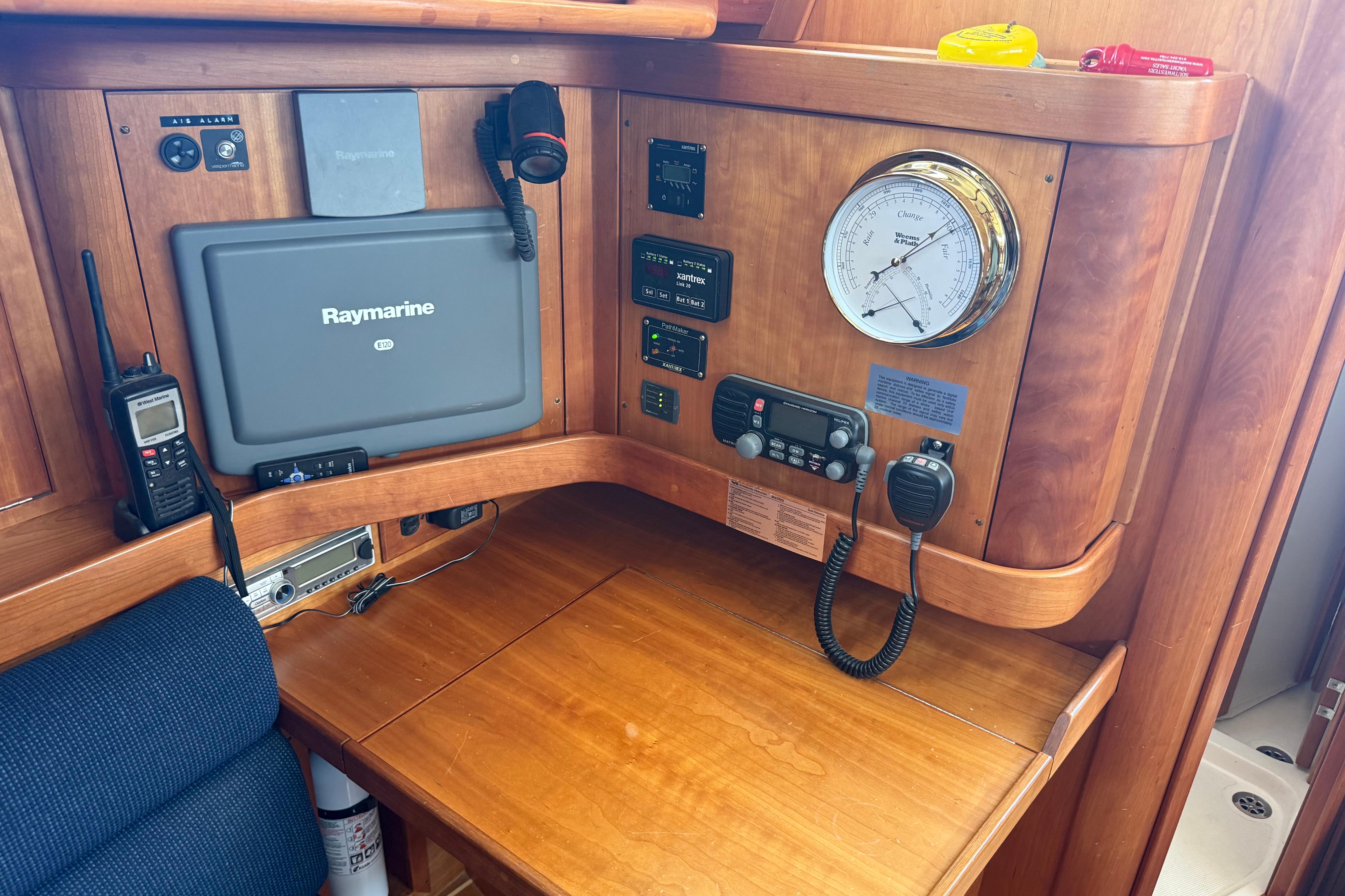 Navigation station on a 2004 Sabre 386 yacht with Raymarine equipment and communication devices.