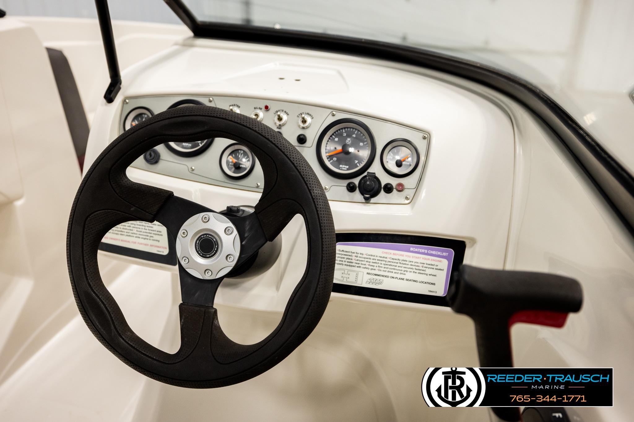 Steering wheel and dashboard of 2016 Tahoe 450 TS boat, featuring gauges and controls.