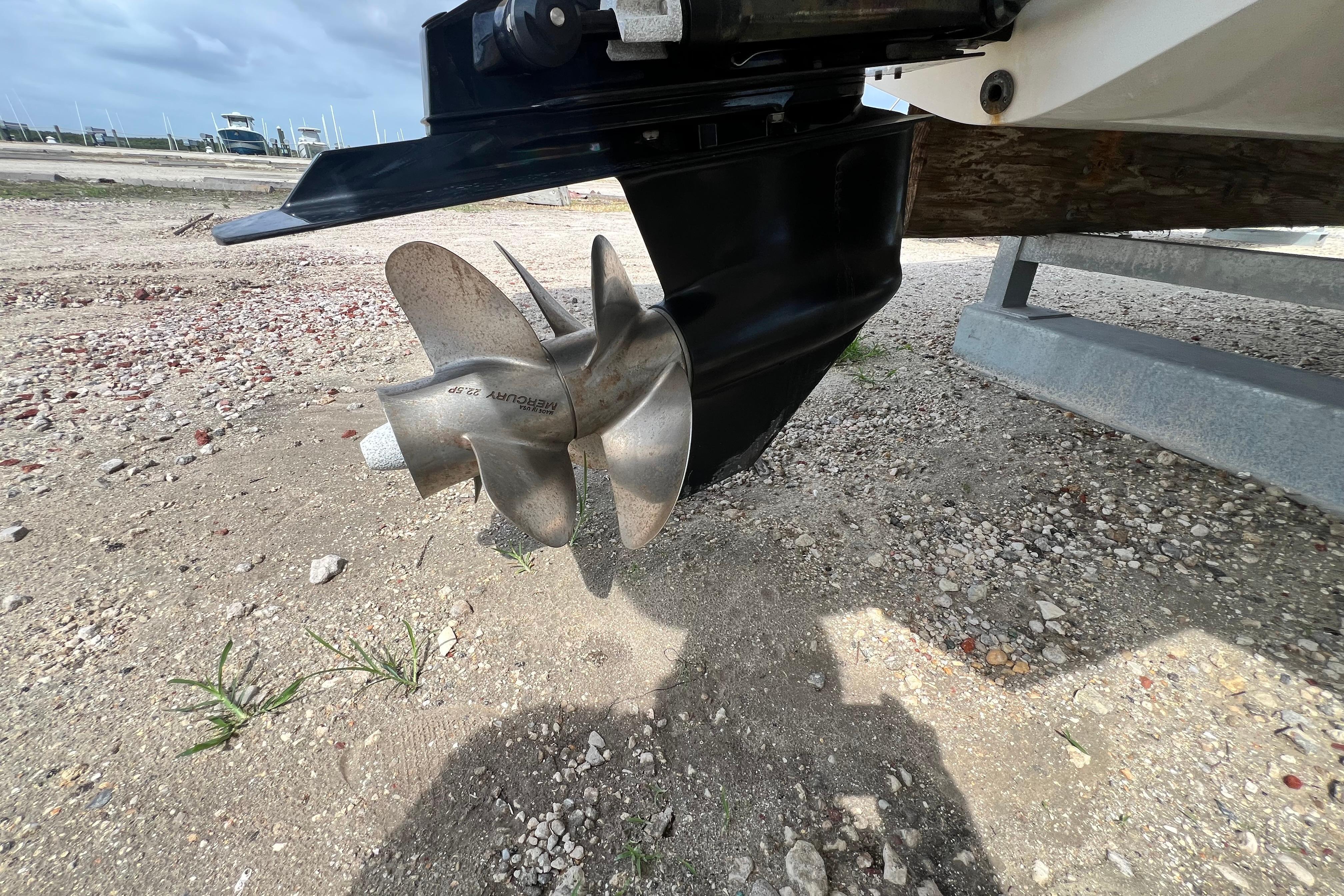 Propeller of a 2015 Monterey 268SS Super Sport boat on a sandy surface.