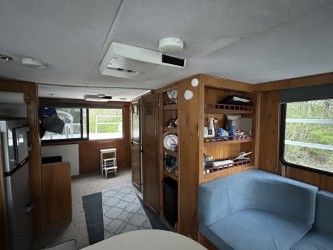 Interior of a 1993 Gibson Sport Series with cozy seating area and kitchen space.