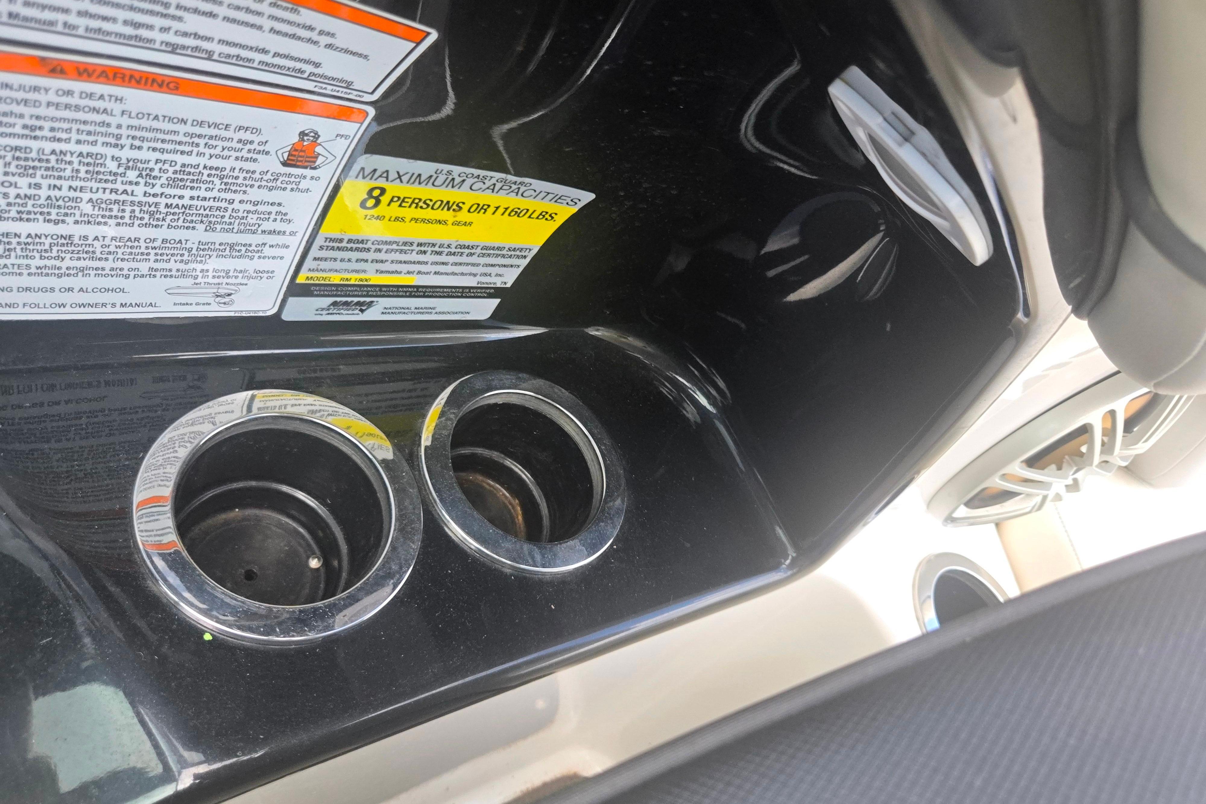 2016 Yamaha Boats AR192 interior with cup holders and capacity warning labels.