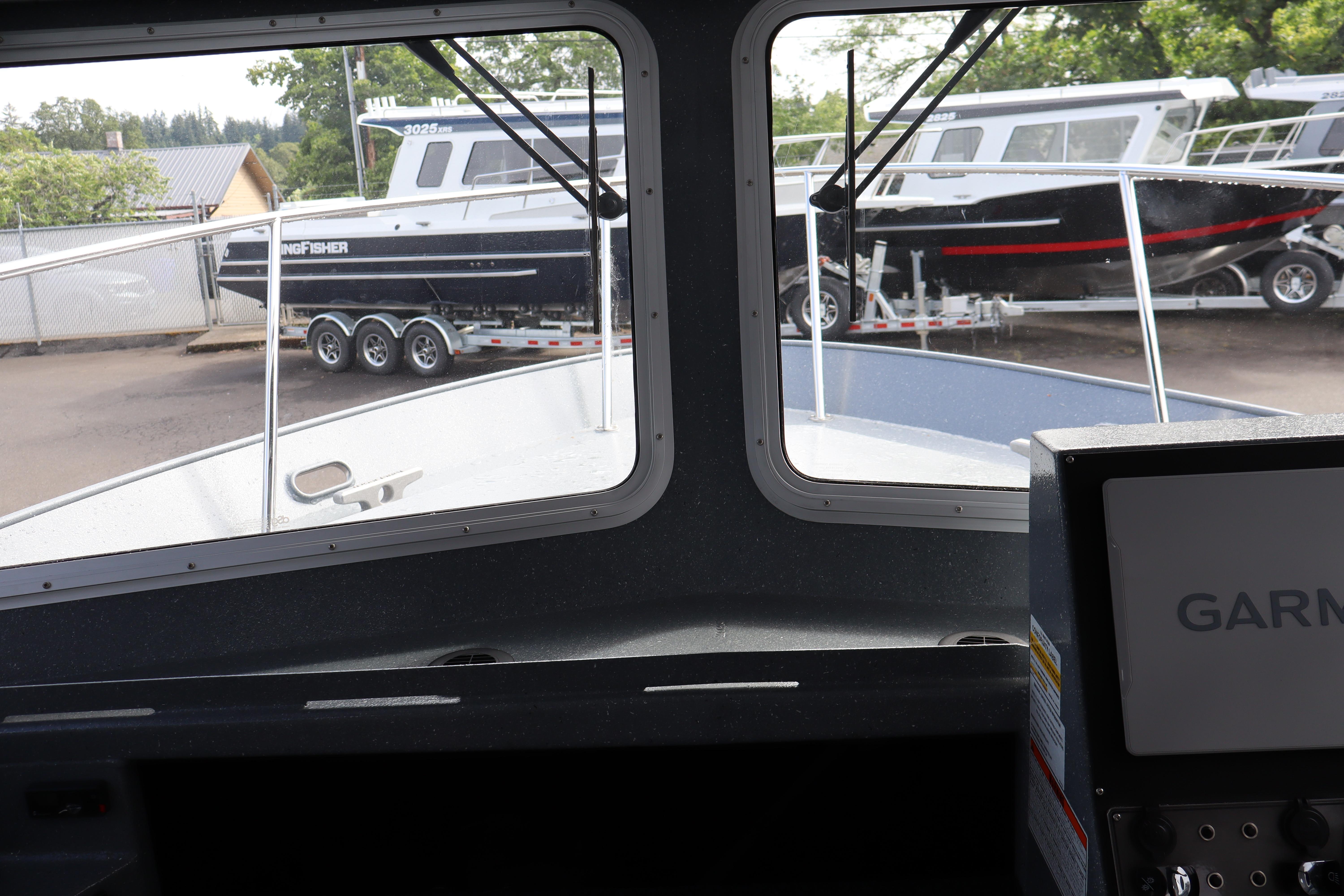 Interior view of 2026 KingFisher 2825 Coastal Express boat, showcasing dashboard and window view.