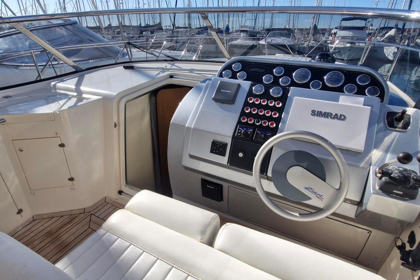 2007 Fiart 34 Genius yacht cockpit with steering wheel and navigation controls.