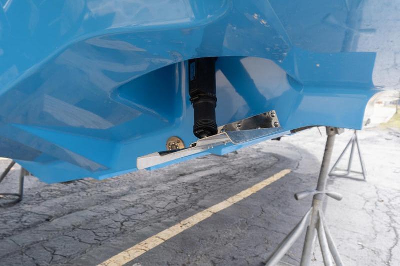 2025 Axopar 29 XC Cross Cabin hull detail on stands, showcasing blue exterior.