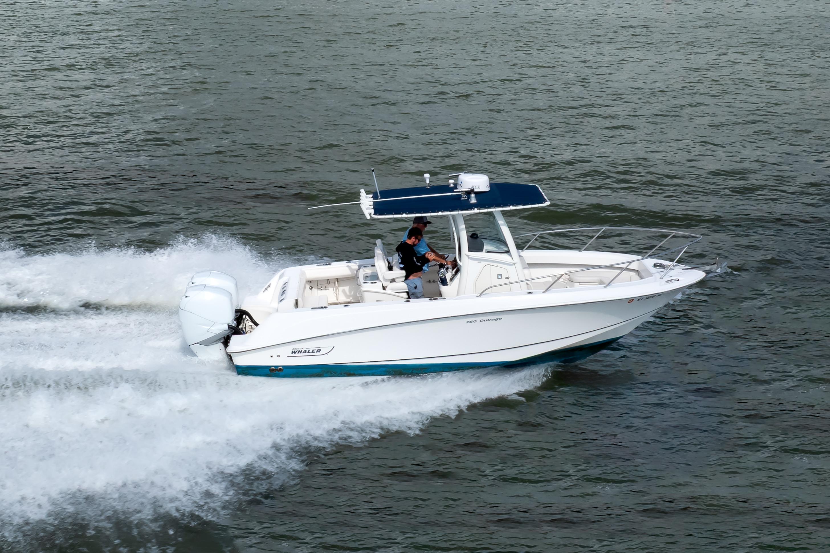 2010 Boston Whaler 250 Outrage cruising on open water, showcasing sleek design and performance.