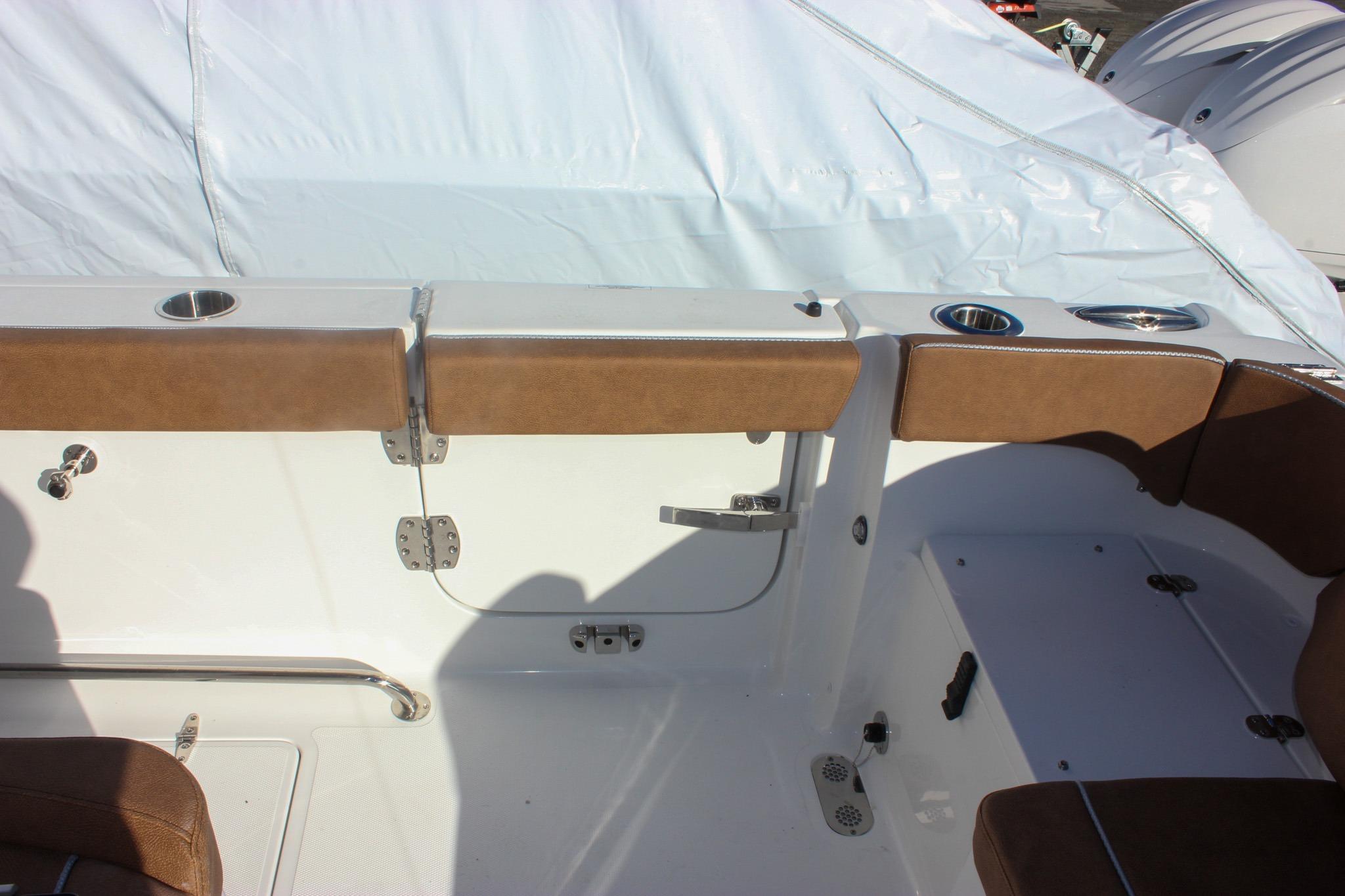 2026 Sea Hunt Ultra 285 SE boat interior with brown seating and cup holders.