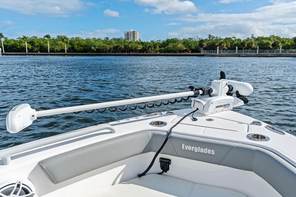 2023 Everglades 243 Center Console boat with Minn Kota trolling motor on calm water.