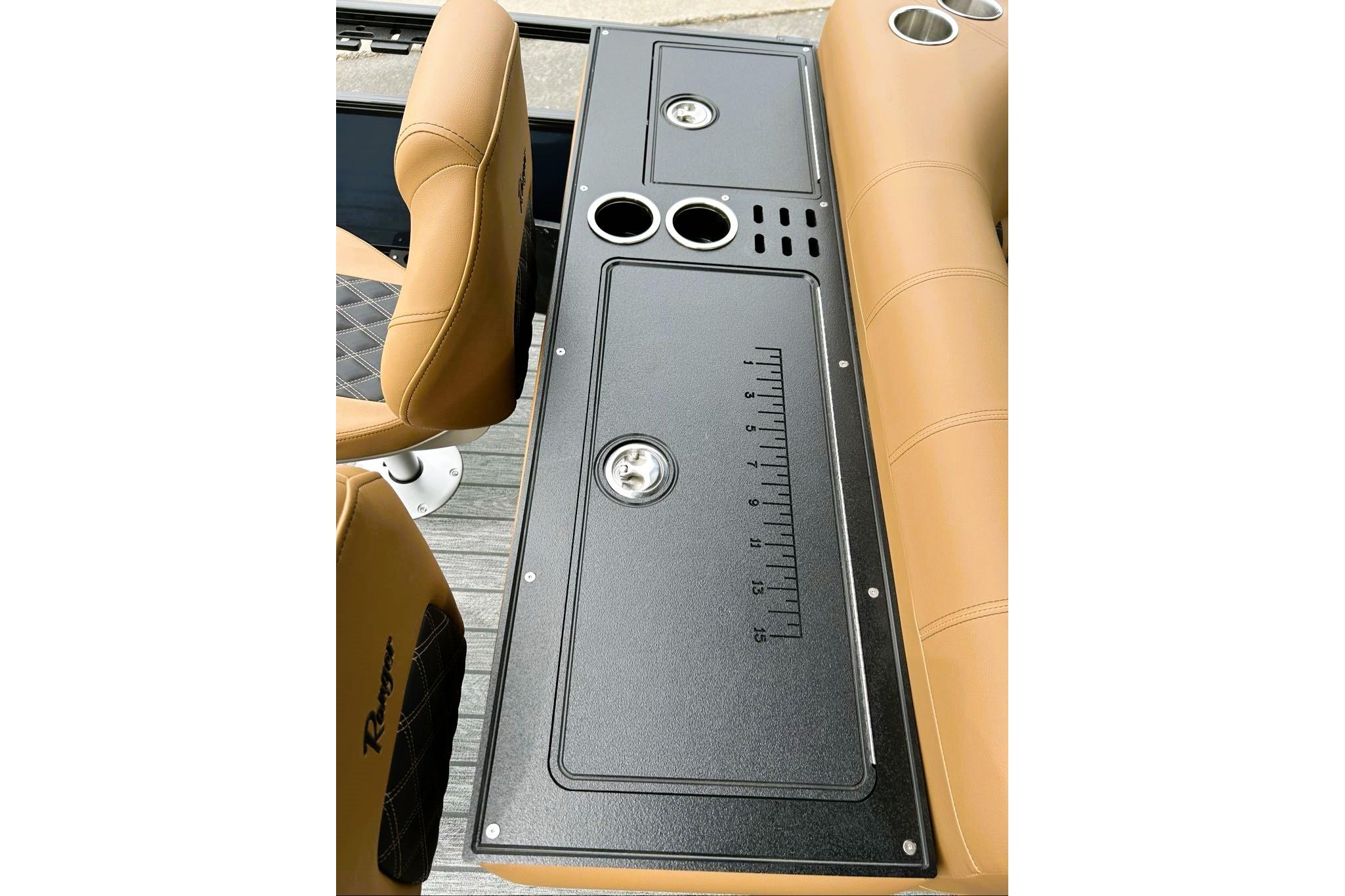 2026 Ranger 220FC boat interior with tan seats and black console featuring cup holders.