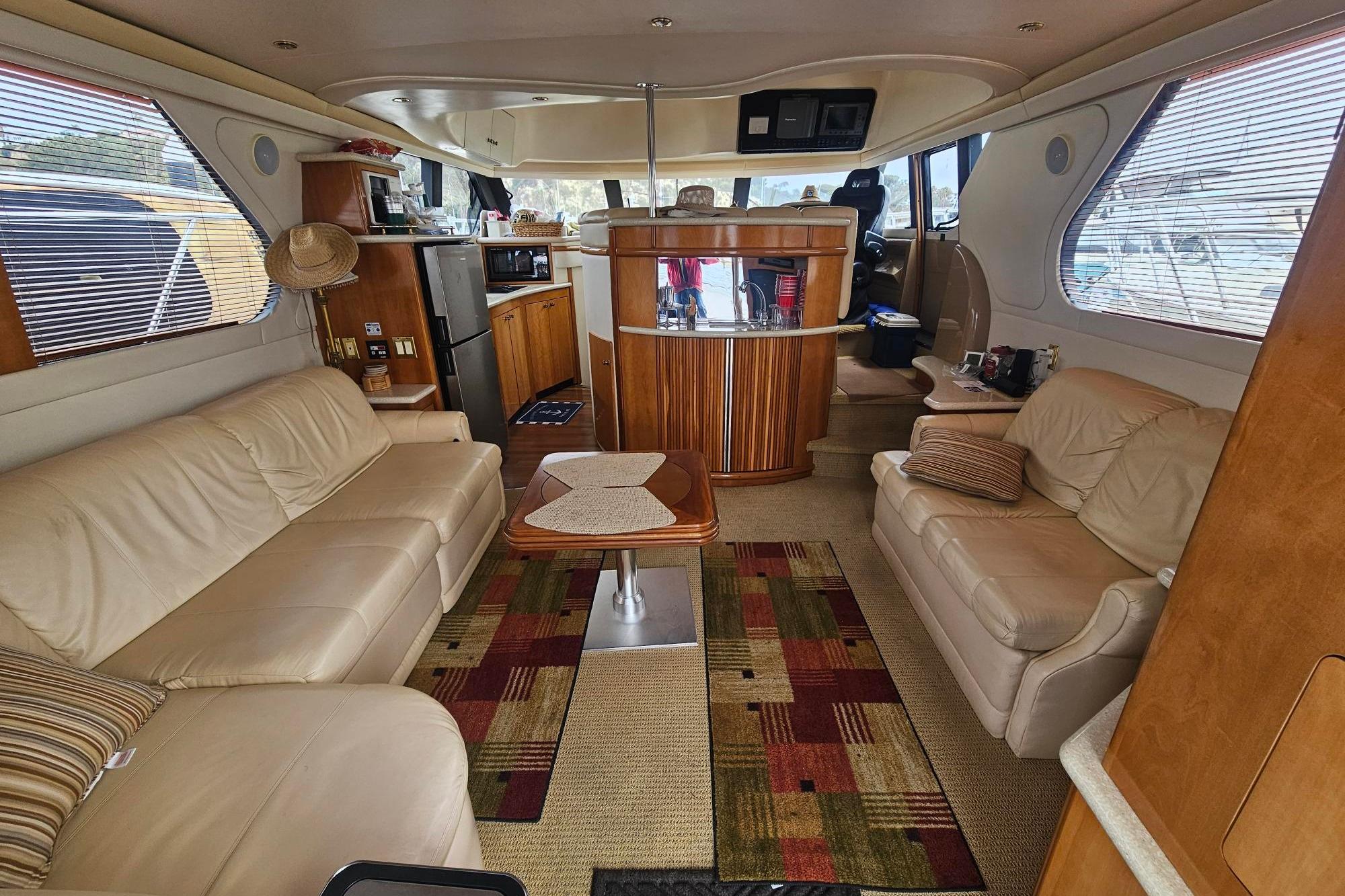 Luxurious interior of a 2002 Carver 450 Voyager Pilothouse yacht with leather seating.