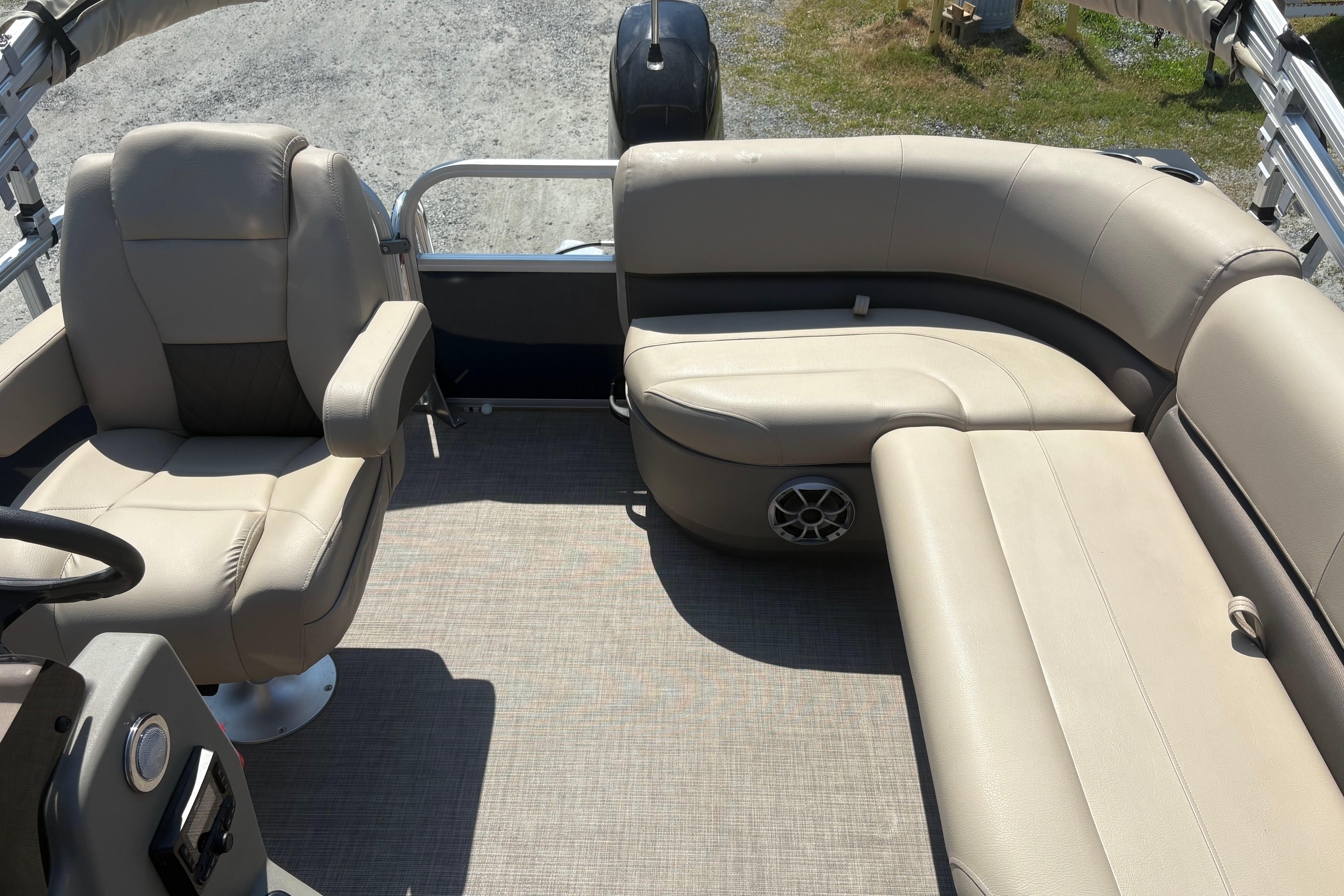 2024 Sun Tracker Bass Buggy 16 DLX interior with beige seating and steering console.