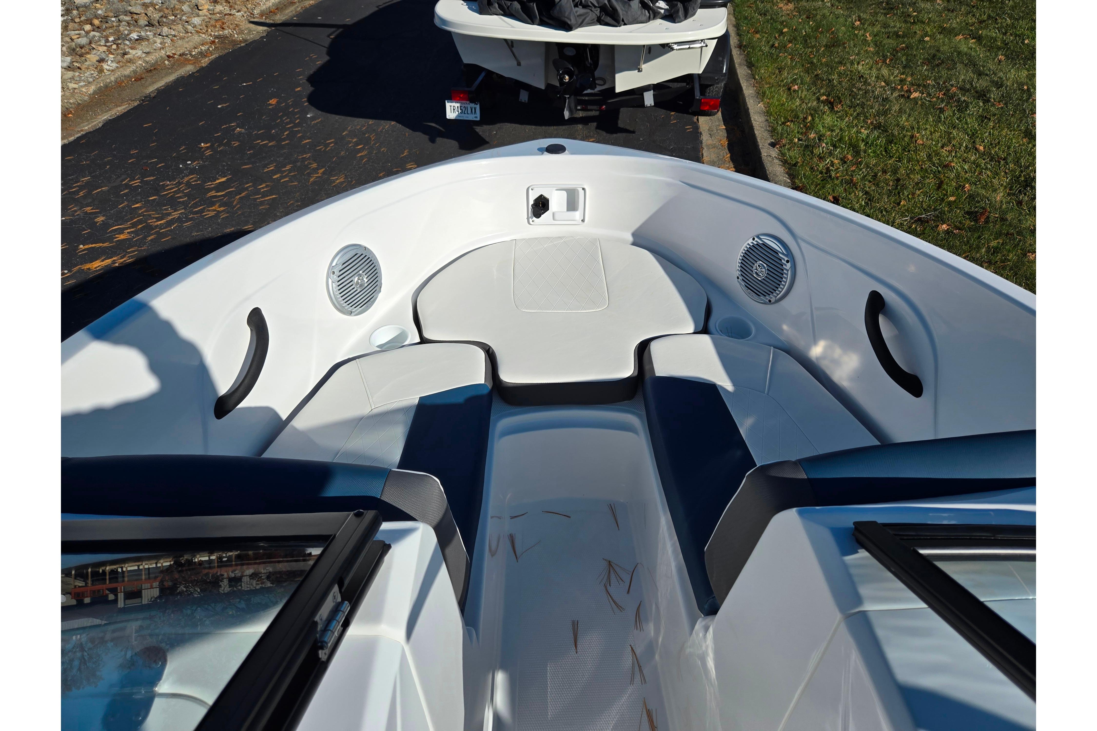 2023 Tahoe 185 S boat interior with seating and speakers, parked on a road.