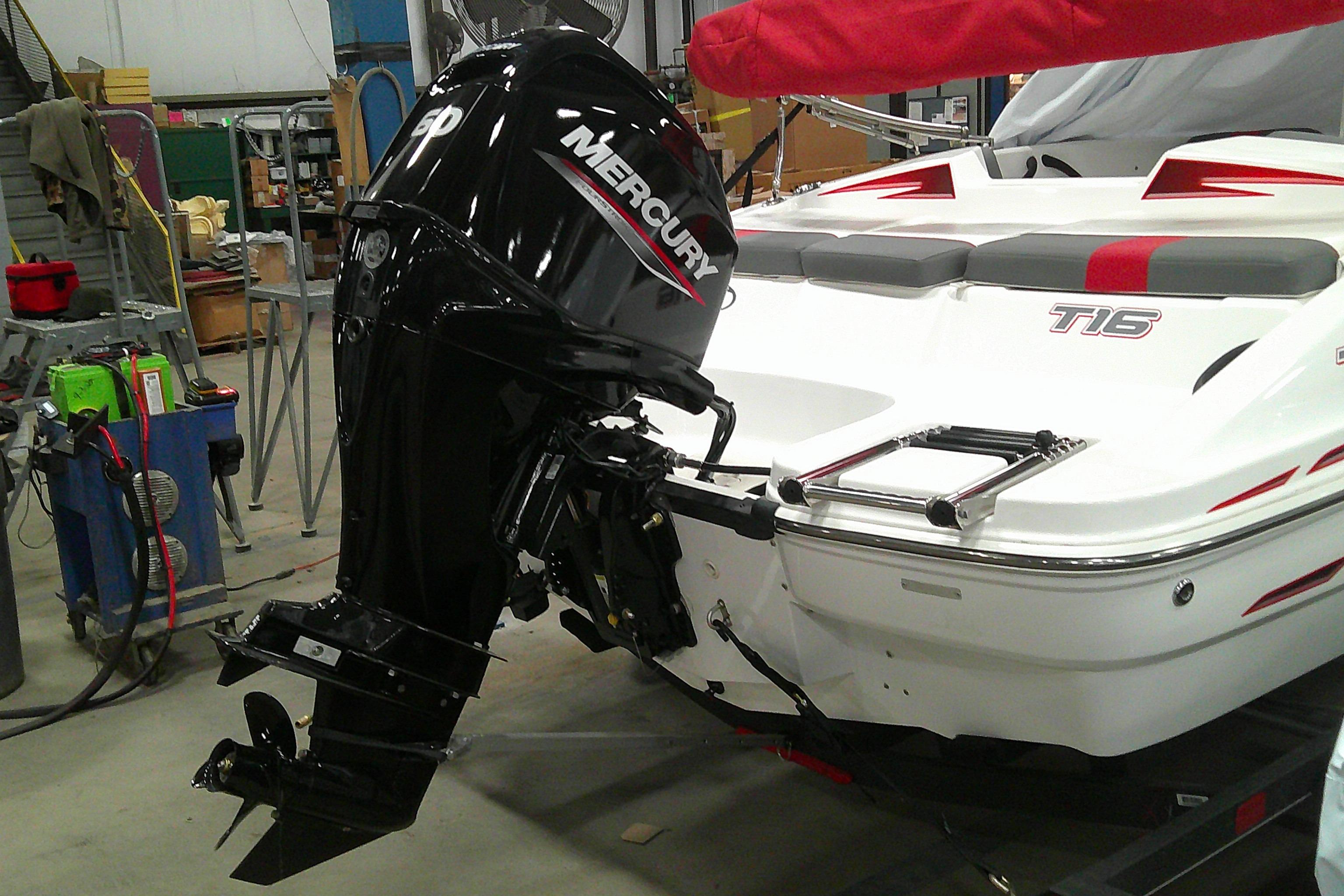 2024 Tahoe T16 boat with Mercury outboard motor in a workshop setting.