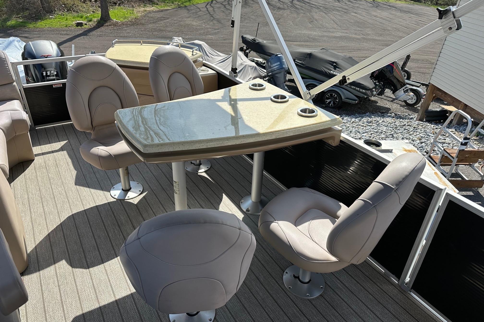 2017 Bennington 22 GPD pontoon boat interior with seating and table.