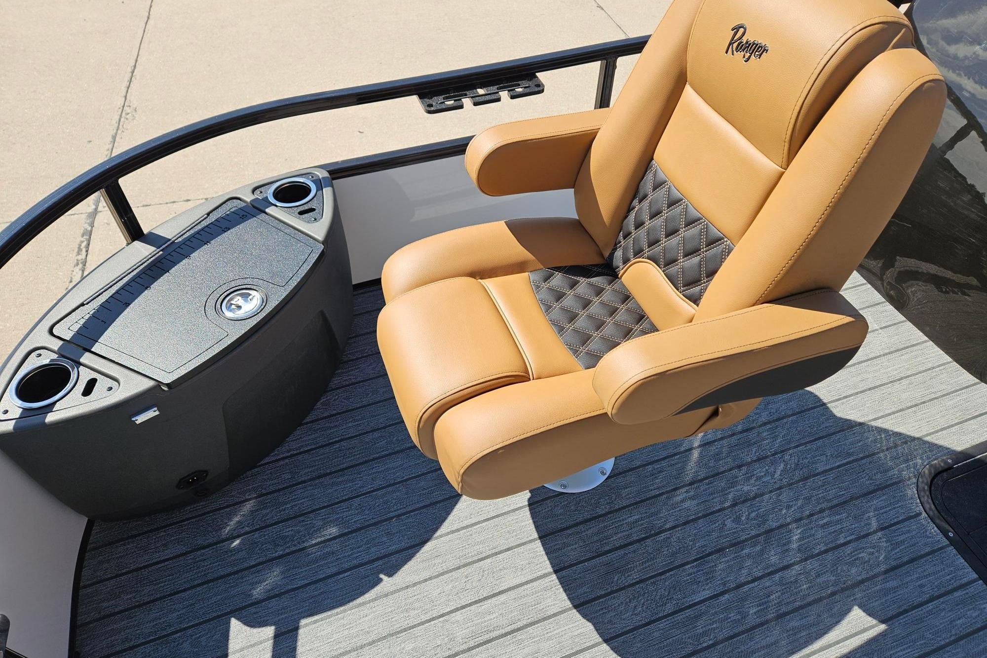 Luxurious tan and black captain's chair on 2026 Ranger 223F boat deck.