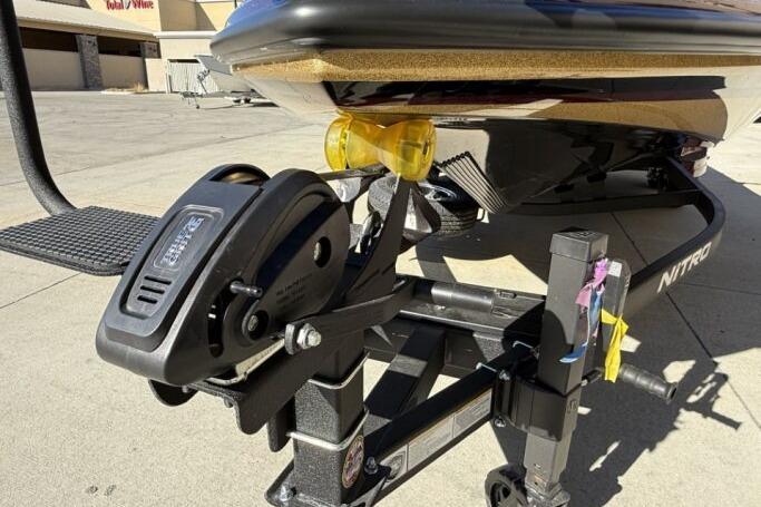 2026 Nitro Z21 XL Pro boat trailer with winch and hitch, parked outdoors.