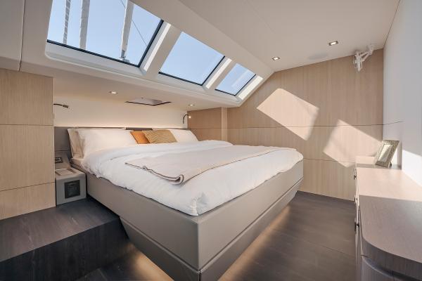 Luxurious bedroom in 2025 Privilege Signature 650 yacht with skylights and modern design.